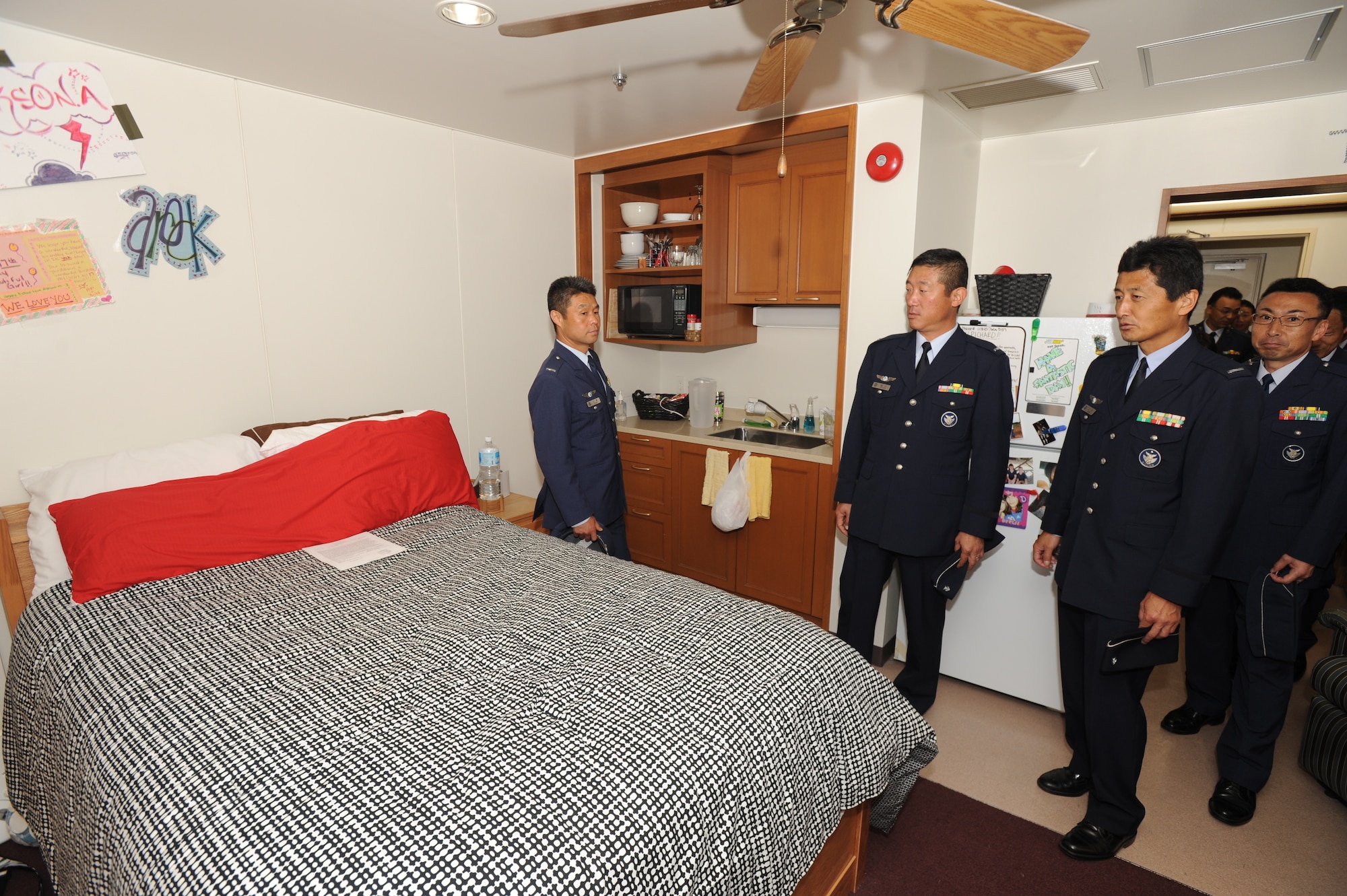 MISAWA AIR BASE, Japan – Japan Air Self-Defense Force warrant officers, whose roles are similar to U.S. Air Force chief master sergeants, and JASDF senior enlisted airmen tour a USAF junior enlisted dormitory room June 18. The tour allowed USAF senior SNCO to display the quality of life provided to Airmen. (U.S. Air Force photo/Senior Airman Jamal Sutter)