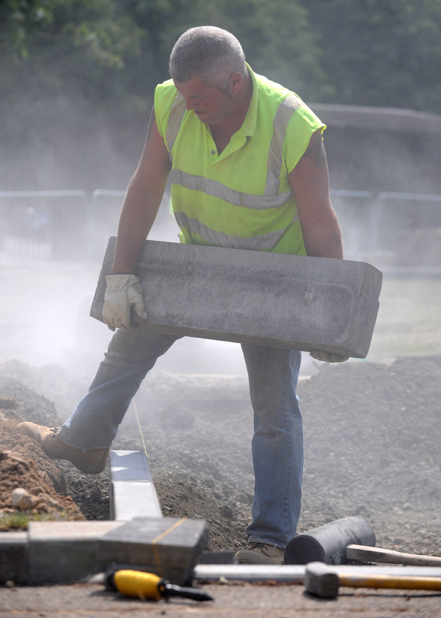RAF MILDENHALL, England – Pete Wood aligns slabs of concrete during construction of an equipment-washing area near Building 543 June 22. The 352nd Special Operations Group-funded project will be used for the group's government equipment.(U.S. Air Force photo/ Staff Sgt. Jerry Fleshman)
