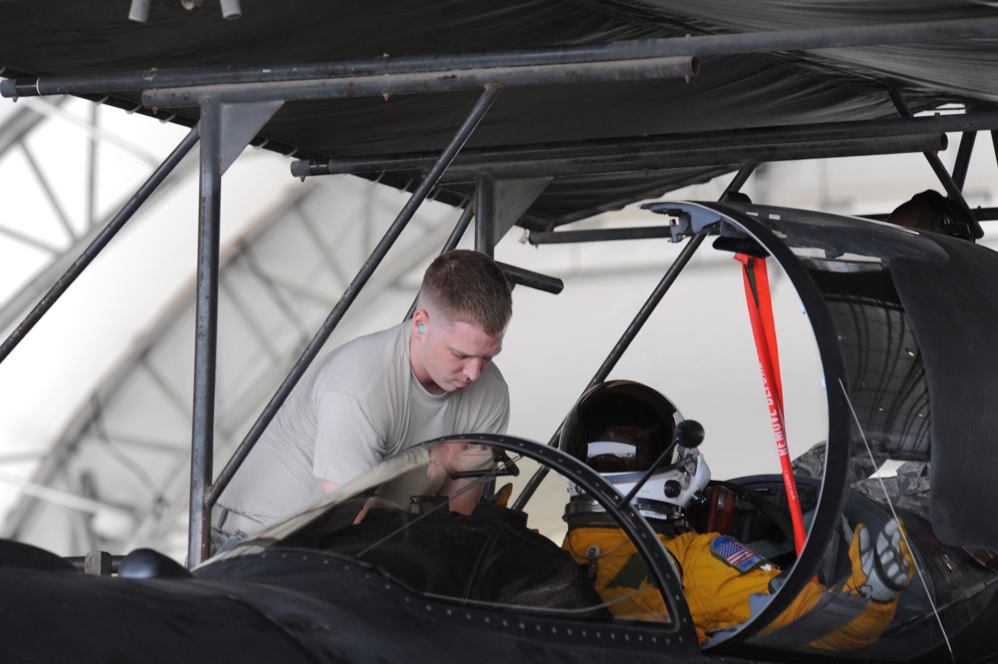 Staff Sgt. Michael McLaughlin, 99th Expeditionary Reconnaissance Squadron physiological support technician, assists Lt. Col. Craig Nowicki 99th ERS U-2 Dragon Lady pilot, prepare for a memorial flight June 22 at a non-disclosed base in Southwest Asia. The memorial flight was the fifth held in honor of Maj. Duane Dively, a U-2 pilot that lost his life in a combat mission. (U.S.  Air Force photo/ Tech. Sgt. April Wickes) 