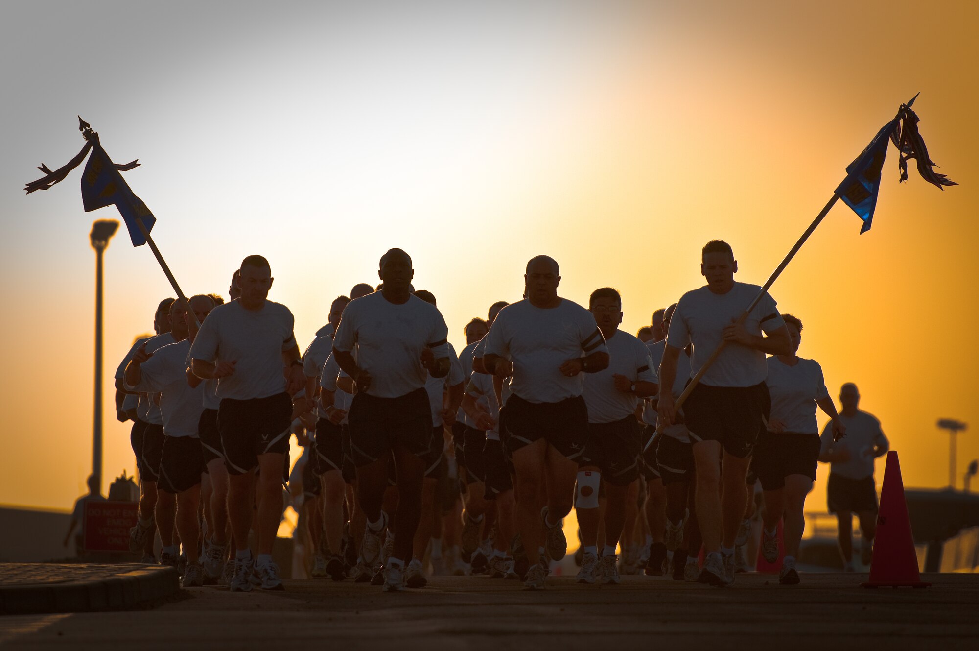 6/23/2010 - SOUTHWEST ASIA - Members of the 386th Expeditionary Mission Support Group conduct physical fitness training here June 23, 2010 as the sun rises over their base. Comprised of approximately 850 Airmen, the unit provides security forces, logistics, contracting, communications and civil engineering services as part of the 386th Air Expeditionary Wing. (U.S. Air Force photo by Maj. Dale Greer/Released)