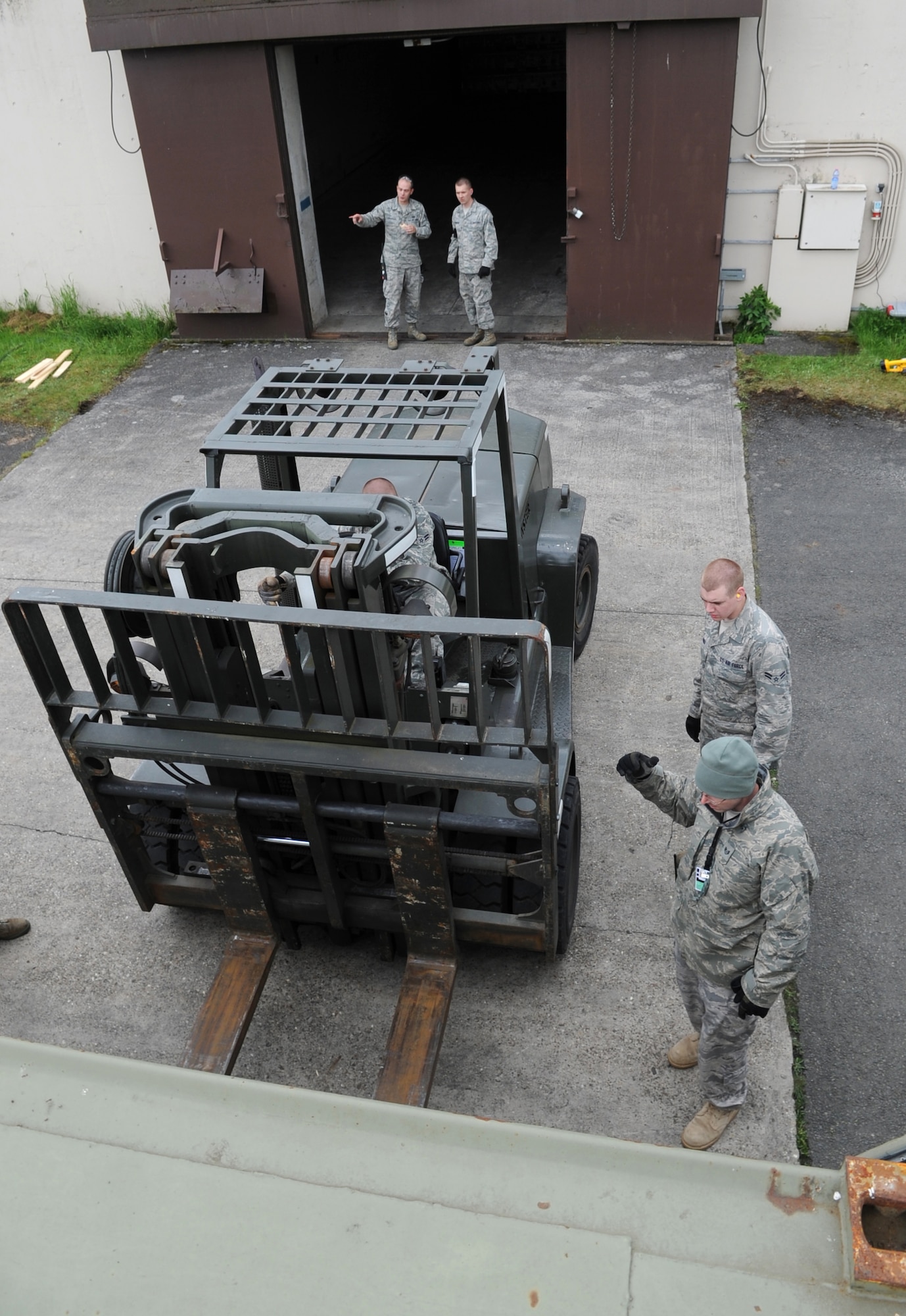 Members of the 86th Munitions Squadron load cargo trailers with munitions, Ramstein Air Base, Germany, May 18, 2010. The 86th MUNS prepared a shipment of numerous international shipping containers as part of an exercise called Turbo Containerized Ammunition Distribution System, or TURBOCADS 2010. (U.S. Air Force photo by Airman 1st Class Caleb Pierce)