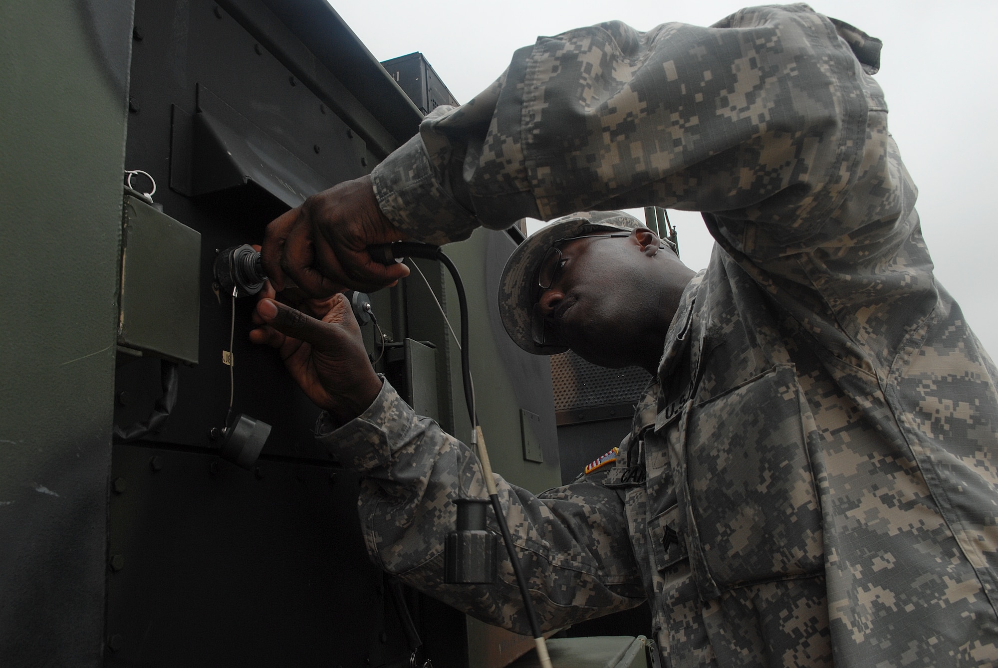 KUNSAN AIR BASE, Republic of Korea -- Sergeant Jerry Carson, 2-1 Air Defense Artillery Alpha Battery patriot operators, connects a fiber optic cable to the Patriot Advanced Capability Launcher. All over Korea, Patriot Advanced Capability Launchers are used in defense of military installations. (U.S. Air Force photo/ Senior Airman Roy Lynch)