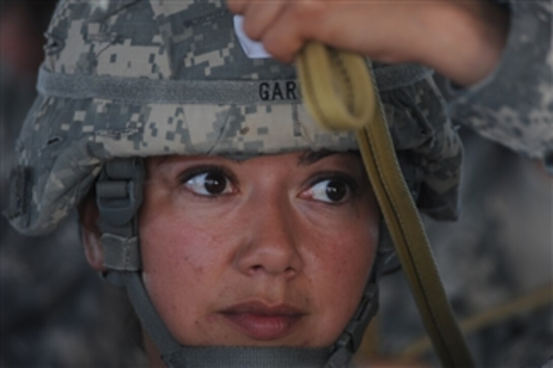 U.S. Army Staff Sgt. Amanda Garcia, with the 82nd Airborne Division, practices jumping techniques during a joint forcible entry exercise at Pope Air Force Base, N.C., on June 21, 2010.  The weeklong exercise is held six times a year and is designed to enhance cohesiveness between the Air Force and Army by executing large scale heavy equipment and troop movements.  