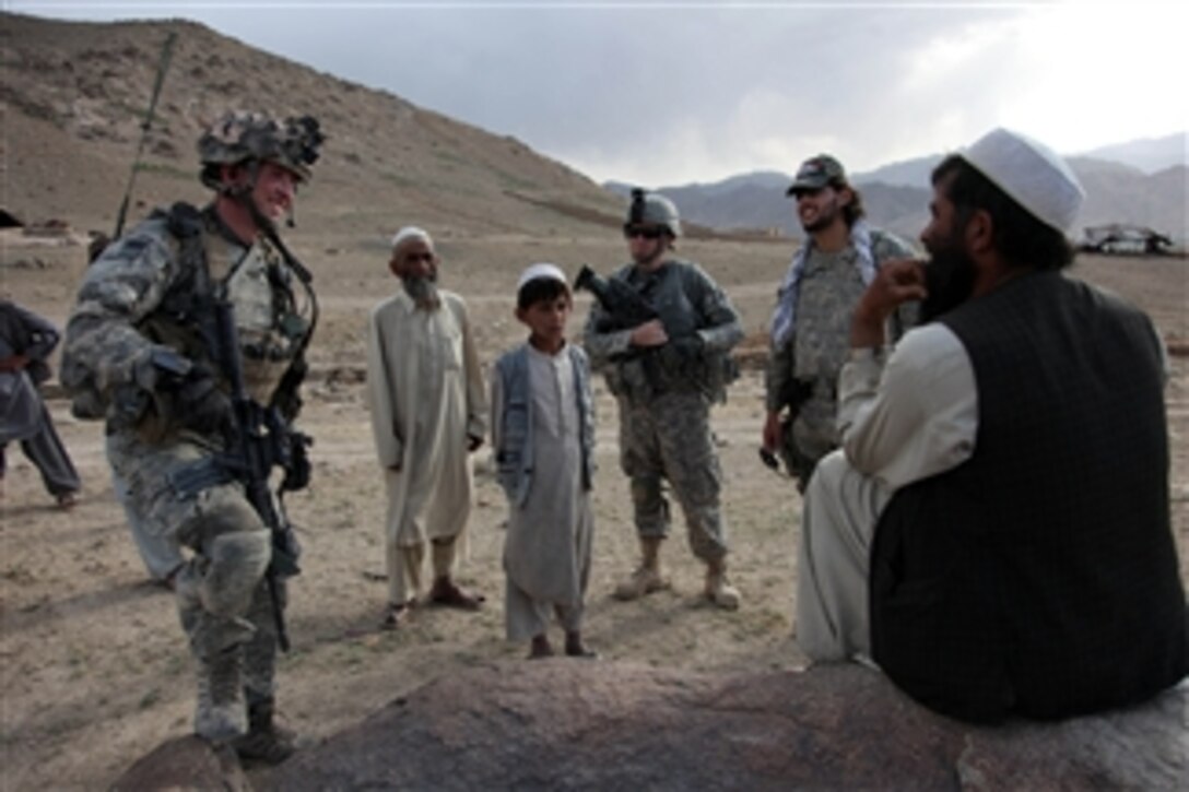 An Afghan man speaks with U.S. Army soldiers while they check on conditions in the village of Paspajak in the Charkh district of the Logar province of Afghanistan on June 20, 2010.  The soldiers are from 1st Platoon, Bravo Troop, 1st Squadron, 91st Cavalry Regiment.  