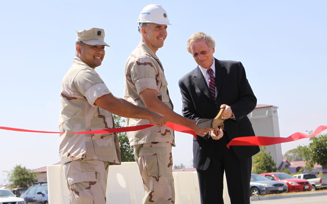 (From left to right) Navy Cmdr. Rafael Lim, officer in charge of construction, Public Works Office, Camp Pendleton, Navy Lt. Cmdr. Scott King, Naval Facilities Engineering Command Southwest resident officer in charge of Construction for Marine Corps Base Camp Pendleton and Richard Straub, project lead , cut the ribbon to unveil a newly designed Force Intelligence Operations Center (FIOC) on Camp Pendleton, June 23.