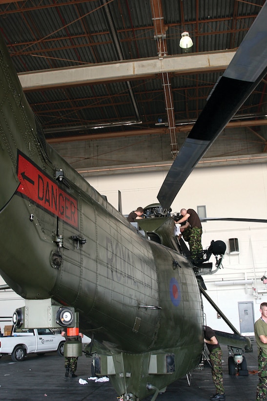 English Royal Marine Commandos and Royal Navy personnel conduct pre-flight checks on the Westland WS-61 "Sea King" helicopter before conducting operations over the Jacksonville area Friday, June 25, 2010.