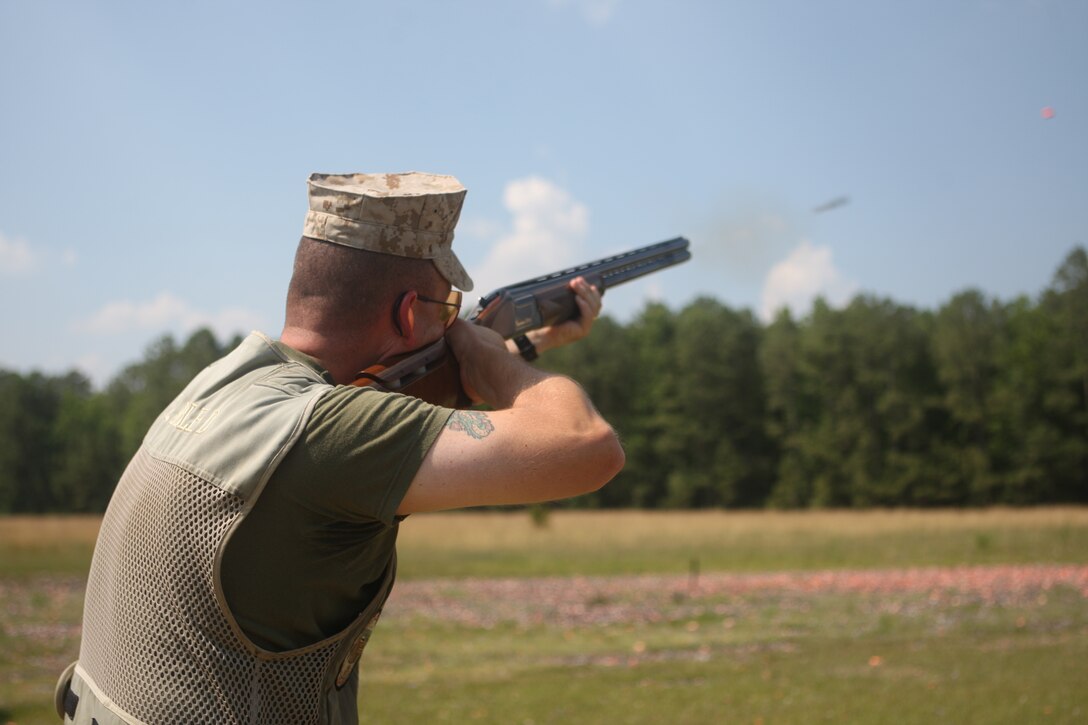 Chief Warrant Officer 3 Darron Todd, maintenance officer with Marine Special Operations School, Marine Special Operations Command, fires a .410 shotgun at an airborne clay pigeon at the McIntyre Skeet Range aboard Marine Corps Base Camp Lejeune, June 25. Todd, part of the All-Marine Skeet Team, is one of eight Marines who are scheduled to represent the Marine Corps and the United States in the upcoming 2010 World Skeet Shooting Championships this October.