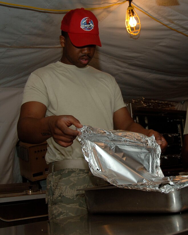 Senior Airman Jonathan Upshur, 820th Expeditionary RED HORSE Squadron Services Airman, checks on the evening meal June 23. Airman Upshur is deployed in support of New Horizons Panama 2010 from the 87th Force Support Squadron, Joint Base McGuire-Dix-Lakehurst, N.J. (U.S. Air Force photo/Tech. Sgt. Eric Petosky)