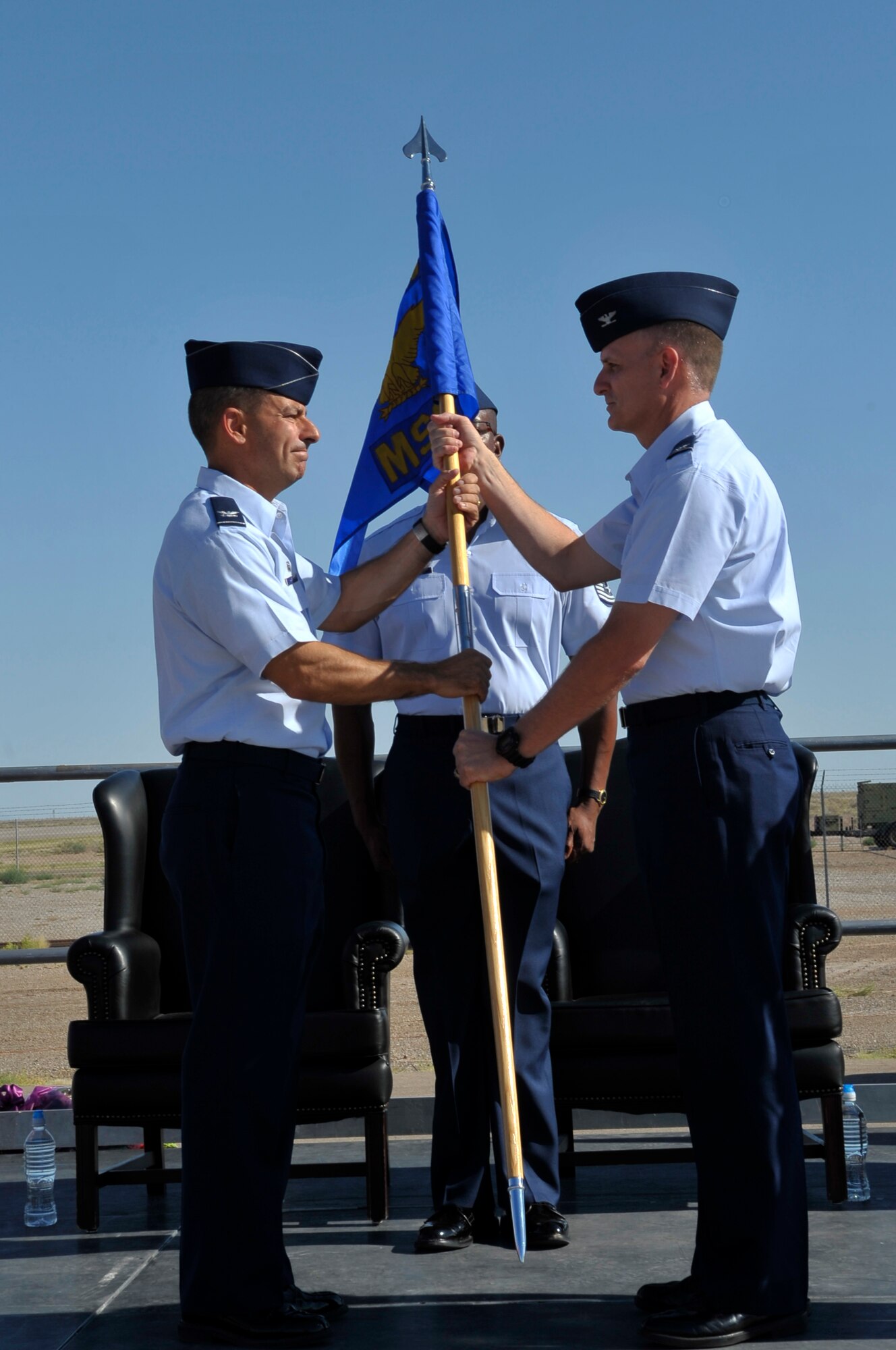 HOLLOMAN AIR FORCE BASE, N.M. -- Col. Robert H. Cole accepts the guideon from Col. Jeff Harrigian, 49th Fighter Wing commander, and assumes command of the 49th Mission Support Group June 21, 2010. Colonel Cole was the director of communications, Air Force Intelligence, surveillance and reconnaissance agency at Lackland AFB, Texas. (U.S. Air Force photo by Airman 1st Class Joshua Turner / Released)
