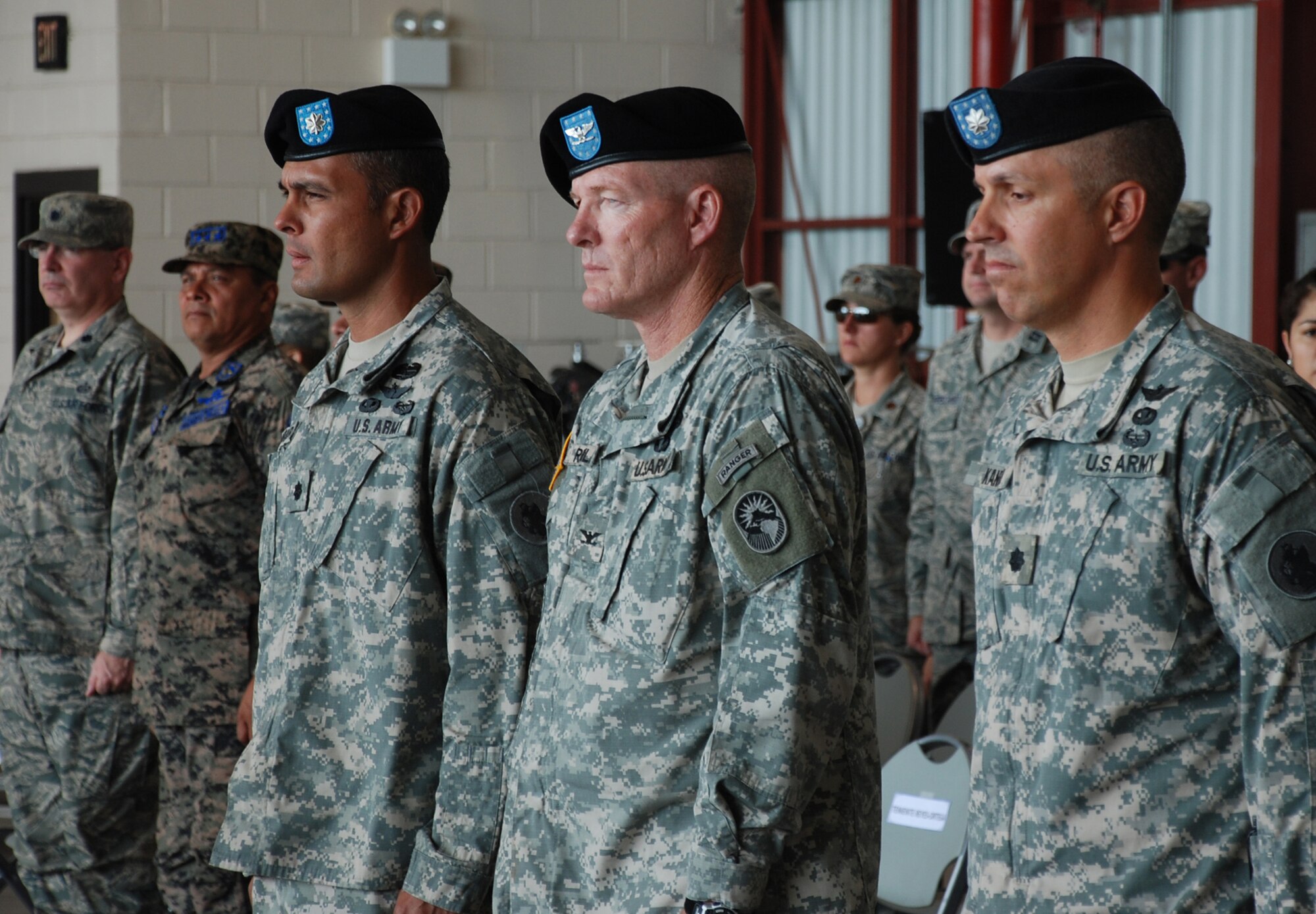 SOTO CANO AIR BASE, Republic of Honduras -- As the 1st Battalion, 228th Aviation Regiment change of command ceremony begins, Col. Gregory Reilly, center, the Joint Task Force-Bravo commander, stands with Lt. Col. Salome Herrera Jr., the outgoing Battalion commander, and Lt. Col. James Kanicki, the incoming Battalion commander, here June 24. During the past year, the Battalion has flown more than 4,300 hours supporting operations such as Unified Response in Haiti and Beyond the Horizons throughout Central America. (U.S. Air Force photo/Tech. Sgt. Benjamin Rojek)