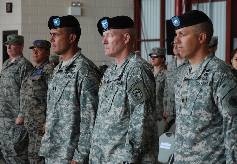 SOTO CANO AIR BASE, Republic of Honduras -- As the 1st Battalion, 228th Aviation Regiment change of command ceremony begins, Col. Gregory Reilly, center, the Joint Task Force-Bravo commander, stands with Lt. Col. Salome Herrera Jr., the outgoing Battalion commander, and Lt. Col. James Kanicki, the incoming Battalion commander, here June 24. During the past year, the Battalion has flown more than 4,300 hours supporting operations such as Unified Response in Haiti and Beyond the Horizons throughout Central America. (U.S. Air Force photo/Tech. Sgt. Benjamin Rojek)