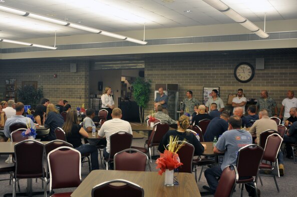 Elaine Schachelmayer, the 128th Air Refueling Wing Airman and Family Program manager, (standing left) expresses her support for deploying security forces team members at Sijan Hall, 128 ARW, Milwaukee, WI, on Wed., June 23, 2010.  Seventeen 128 ARW security forces team members departed for combat skills training at Fort Dix, NJ, and will continue overseas to their assigned deployment location.  (U.S. Air Force photo by Senior Airman Ryan Kuntze / Released)