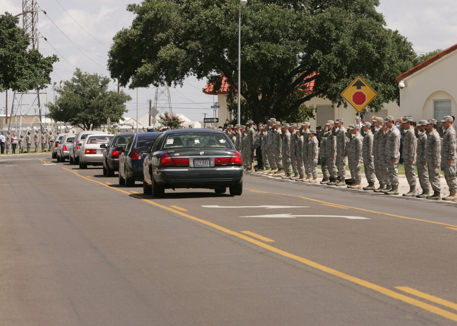 Thousands of men and women from Lackland line the street June 18 as a show of respect for Tech. Sgt. Michael Flores, an Airman from San Antonio killed while supporting Operation Enduring Freedom. Sergeant Flores was assigned to the 48th Rescue Squadron, Davis-Monthan Air Force Base, Ariz. (U.S. Air Force photo/Robbin Cresswell)
