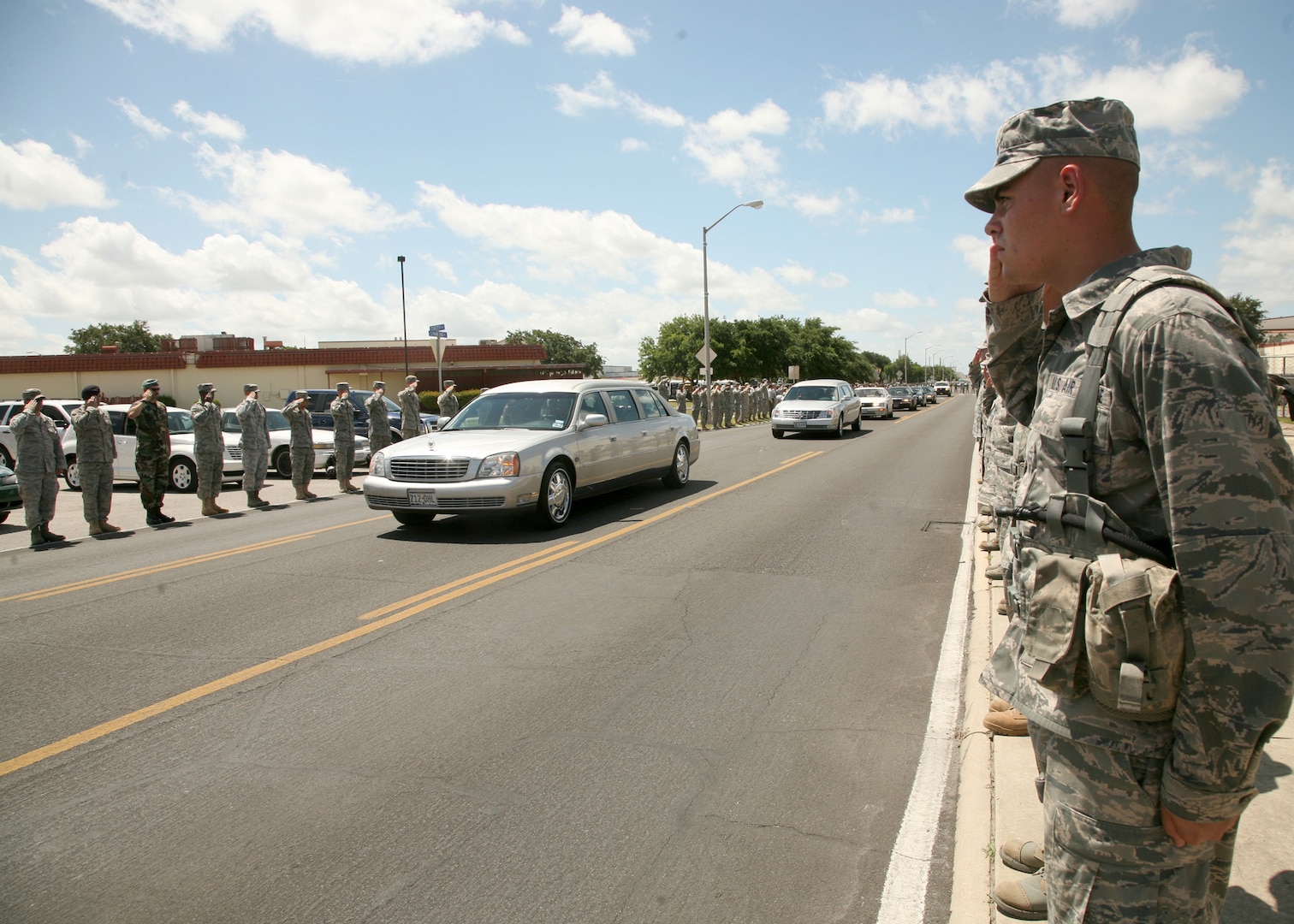 Thousands of men and women from Lackland line the street June 18 as a show of respect for Tech. Sgt. Michael Flores, an Airman from San Antonio killed while supporting Operation Enduring Freedom. Sergeant Flores was assigned to the 48th Rescue Squadron, Davis-Monthan Air Force Base, Ariz. (U.S. Air Force photo/Robbin Cresswell)
