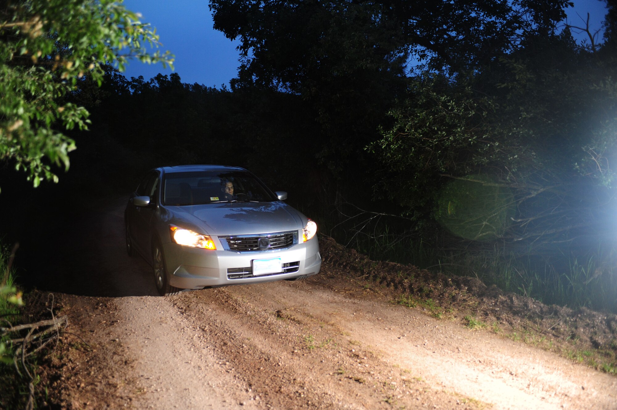 ELLSWORTH AIR FORCE BASE, S.D. -- Senior Airman David Carter, 28th Maintenance Squadron aerospace ground equipment journeyman, drives down a winding dirt road the night of June 23.  It’s important if taking long trips to drive safely as well as get adequate sleep before operating a vehicle. (U.S Air Force photo/Airman 1st Class Anthony Sanchelli)