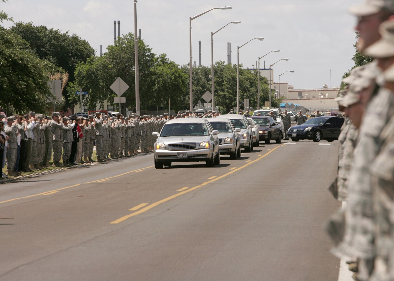 Thousands of men and women from Lackland line the street June 18 as a show of respect for Tech. Sgt. Michael Flores, an Airman from San Antonio killed while supporting Operation Enduring Freedom. Sergeant Flores was assigned to the 48th Rescue Squadron, Davis-Monthan Air Force Base, Ariz. (U.S. Air Force photo/Robbin Cresswell)
