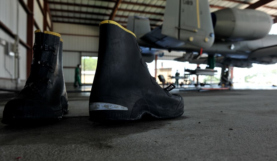 MOODY AIR FORCE BASE, Ga. -- In addition to a protective suit and mask, rubber boots are worn while washing an A-10C Thunderbolt II here June 16. Since a special solution is used as soap, Airmen must wear the entire gear while washing the aircraft. (U.S. Air Force photo by Airman 1st Class Joshua Green/RELEASED)