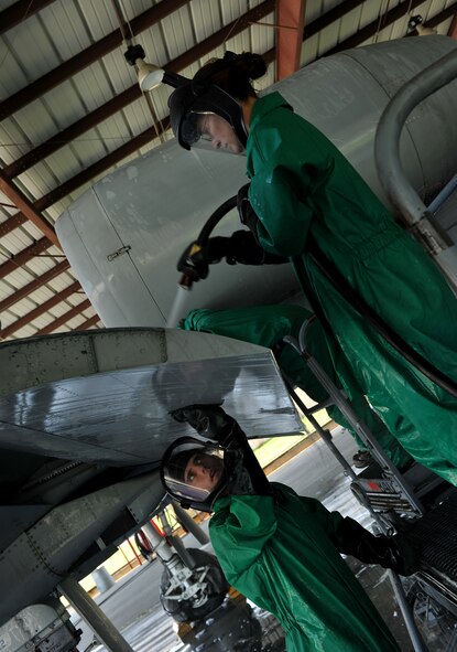 MOODY AIR FORCE BASE, Ga. -- Airmen 1st Class Travis Jones, 23rd Aircraft Maintenance Squadron weapons armament journeyman, and Judith Bulkley, 23rd AMXS electrical and environmental journeyman, rinse the wing flap of an A-10C Thunderbolt II here June 16. (U.S. Air Force photo by Airman 1st Class Joshua Green/RELEASED)