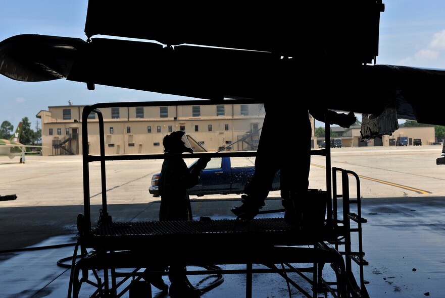 MOODY AIR FORCE BASE, Ga. -- Airmen 1st Class Travis Jones, 23rd Aircraft Maintenance Squadron weapons armament journeyman, and Judith Bulkley, 23rd AMXS electrical and environmental journeyman, soap the underbelly of an A-10C Thunderbolt II here June 16. Due to high temperatures and risk of heat exhaustion, they worked for an hour and took a break for 10 minutes to rest and hydrate. (U.S. Air Force photo by Airman 1st Class Joshua Green/RELEASED)