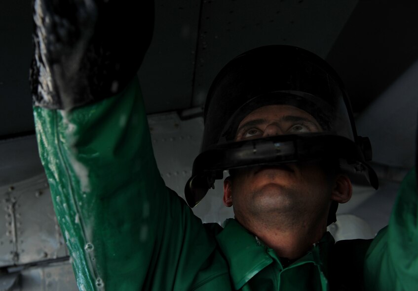 MOODY AIR FORCE BASE, Ga. -- Airman 1st Class Travis Jones, 23rd Aircraft Maintenance Squadron weapons armament journeyman, cleans the under carriage of an A-10C Thunderbolt II here June 16. Airmen are required to wear proper protective gear, including a mask, to prevent exposure to the cleaning chemical on their eyes or body parts. (U.S. Air Force photo by Airman 1st Class Joshua Green/RELEASED)