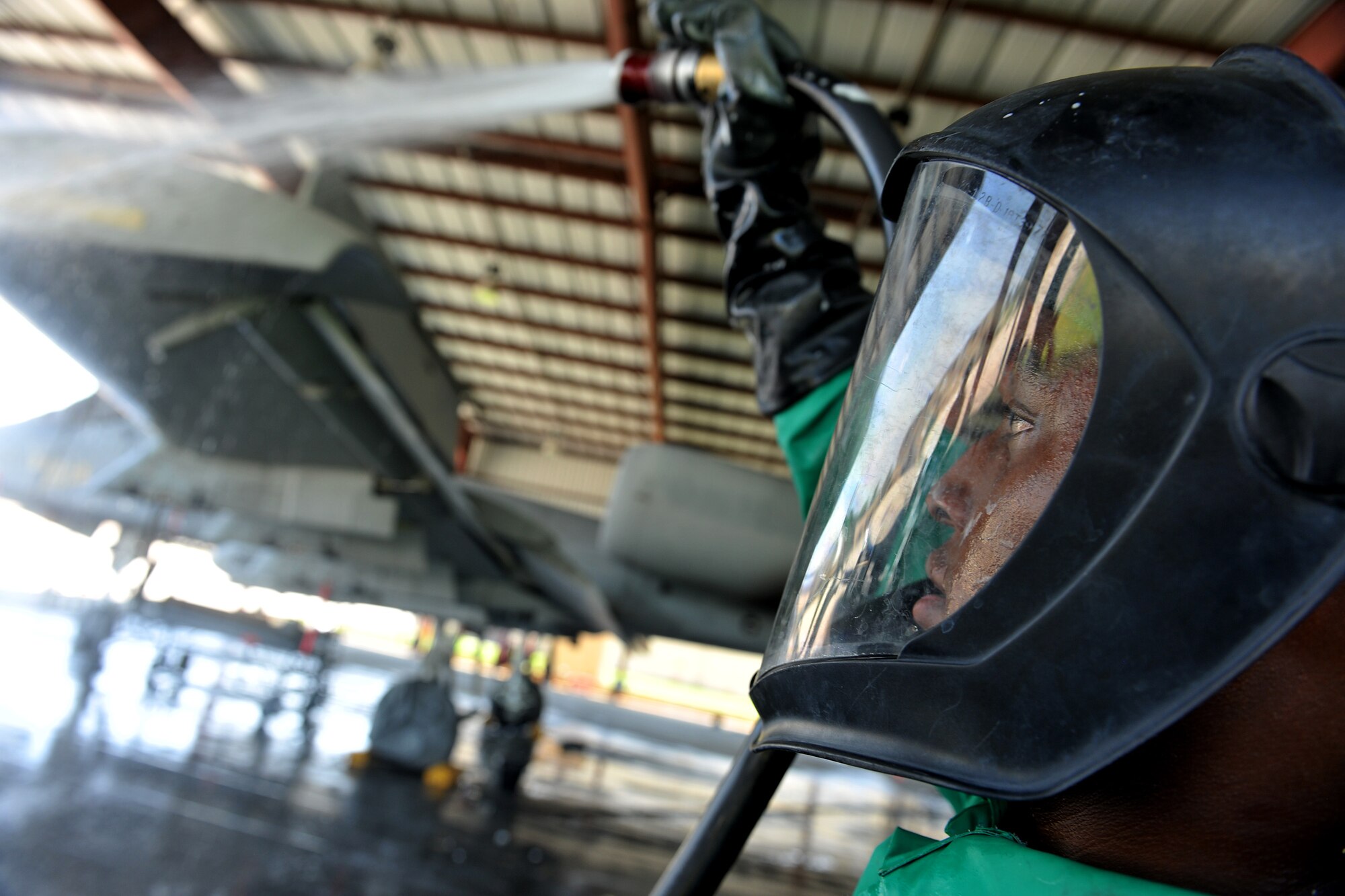 MOODY AIR FORCE BASE, Ga. -- Senior Airman Eldrin Davidson, 23rd Aircraft Maintenance Squadron crew chief, hoses down an A-10C Thunderbolt II after applying soap on the aircraft here June 16. While at home station or deployed, the aircraft is washed every 180 days. (U.S. Air Force photo by Airman 1st Class Joshua Green/RELEASED) 