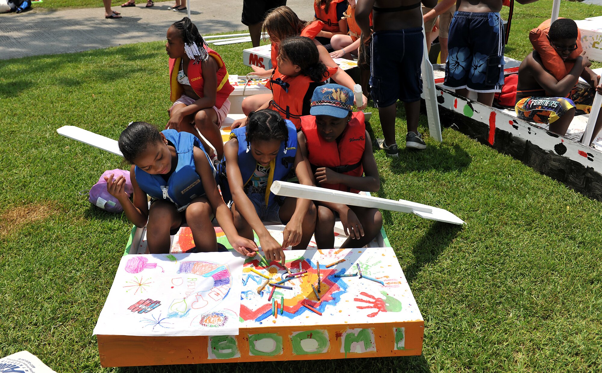 MOODY AIR FORCE BASE, Ga. -- Youth make flags for their sailboats during the Youth Center Launching event at Grassy Pond in Valdosta, Ga., June 18. They built, painted, made flags and named their sailboats, which took approximately a week to complete. (U.S. Air Force photo by Airman 1st Class Joshua Green/RELEASED)