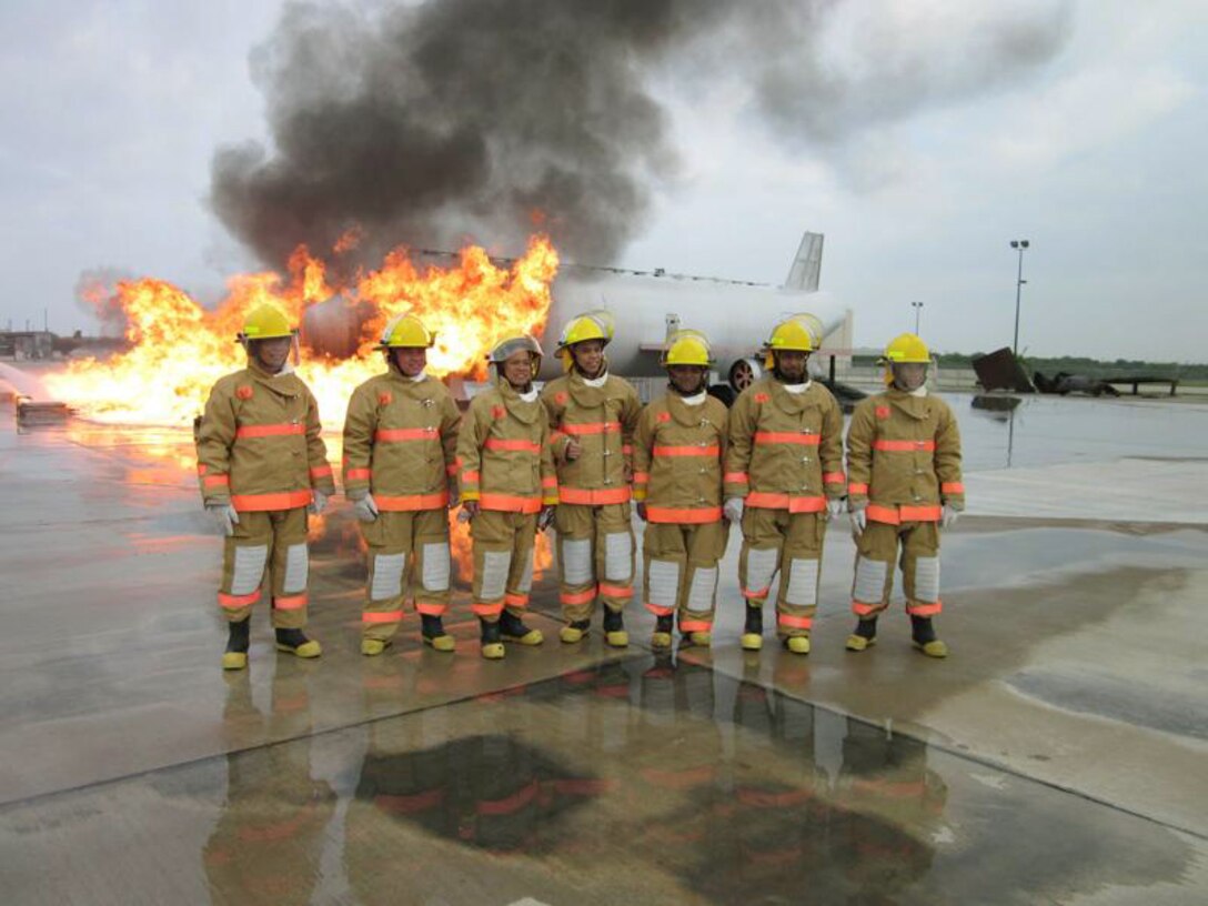 Civil Engineers from the Asia-Pacific region participating in a subject matter expert exchange called Pacific Unity take time for a group photo following a fire training simulation June 4, 2010, at Goodfellow Air Force Base, Texas. (Courtesy photo) 

