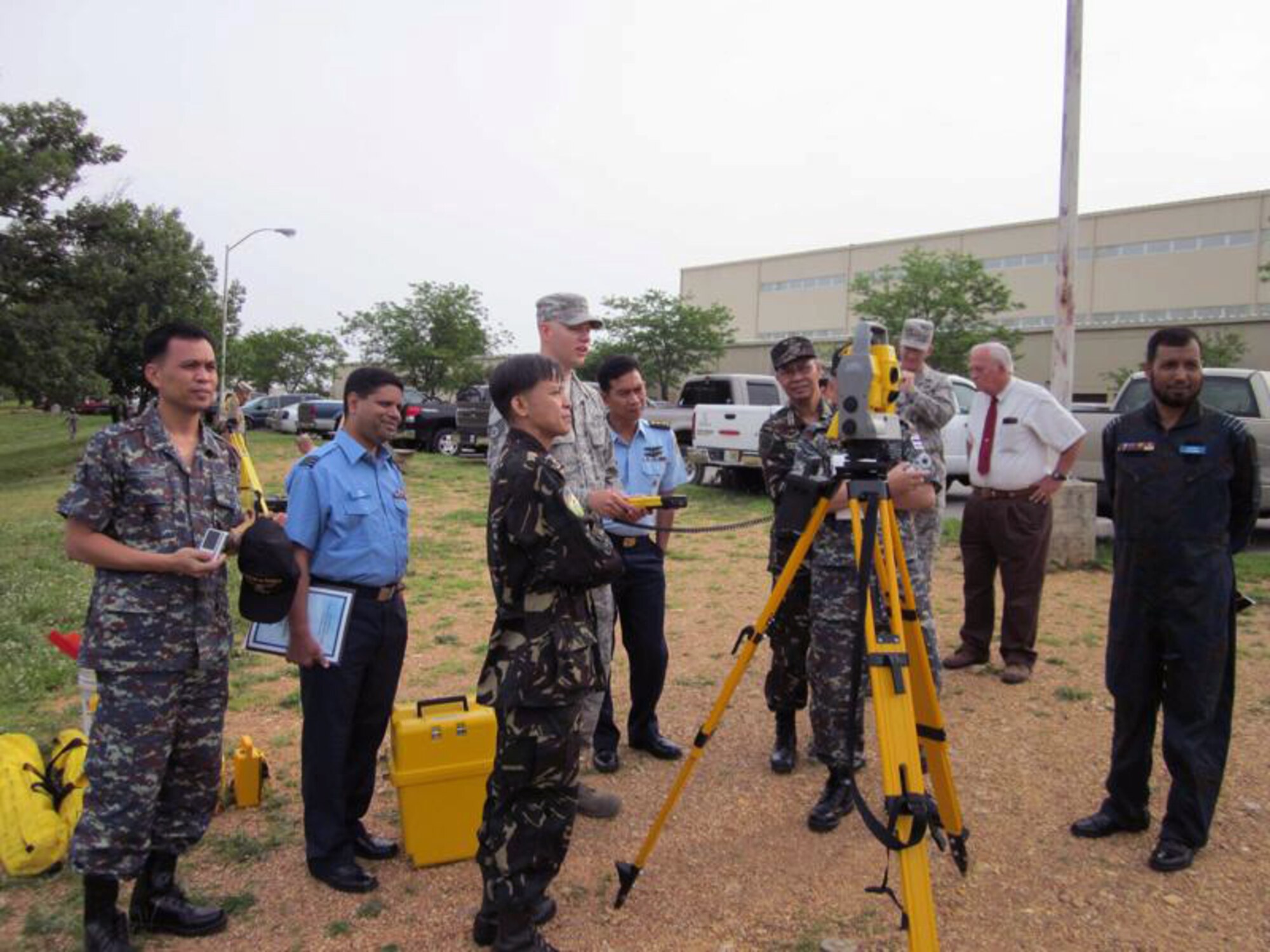 Civil Engineers from the Asia-Pacific region participating in a subject matter expert exchange called Pacific Unity watch as an Airman conducts an engineering survey June 4, 2010, at Fort Leonard Wood, Mo. The SMEE is a joint and combined military information sharing forum that provides mid-level officers from regional Asia-Pacific partner nations to exchange views, tour U.S. military facilities and programs, and establish international and interpersonal relationships. The exchange included officers from Bangladesh, Indonesia, the Philippines and Thailand and focused on emergency-management preparation, disaster-response, fire prevention, confined spaces, search and rescue, and general contingency engineering tactics. (Courtesy photo)