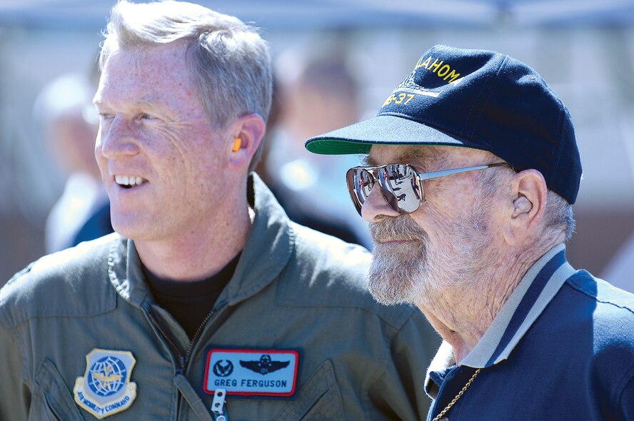 Mr. Vezey and 137th Air?Refueling Wing commander, Col. Greg Ferguson, watch as the mast is unloaded from an Air National Guard C-17. (Air Force photos by Margo Wright)