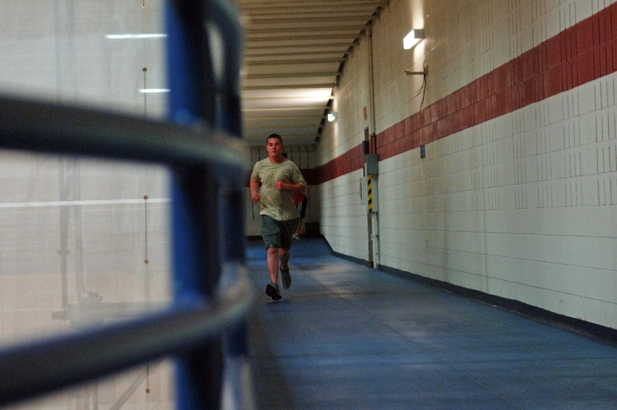 ELLSWORTH AIR FORCE BASE, S.D. – Airman 1st Class Jody Harding, 28th Maintenance Squadron trailer maintenance specialist, runs around the indoor track at the Bellamy Fitness Center, June 22. “I’m going to rock the new test,” said Airman Harding. “I can run the mile and a half in about 9:25 and max out my pushups and sit-ups, so I’ll definitely get a 90 or better.” (U.S. Air Force photo / Airman 1st Class Jarad A. Denton)