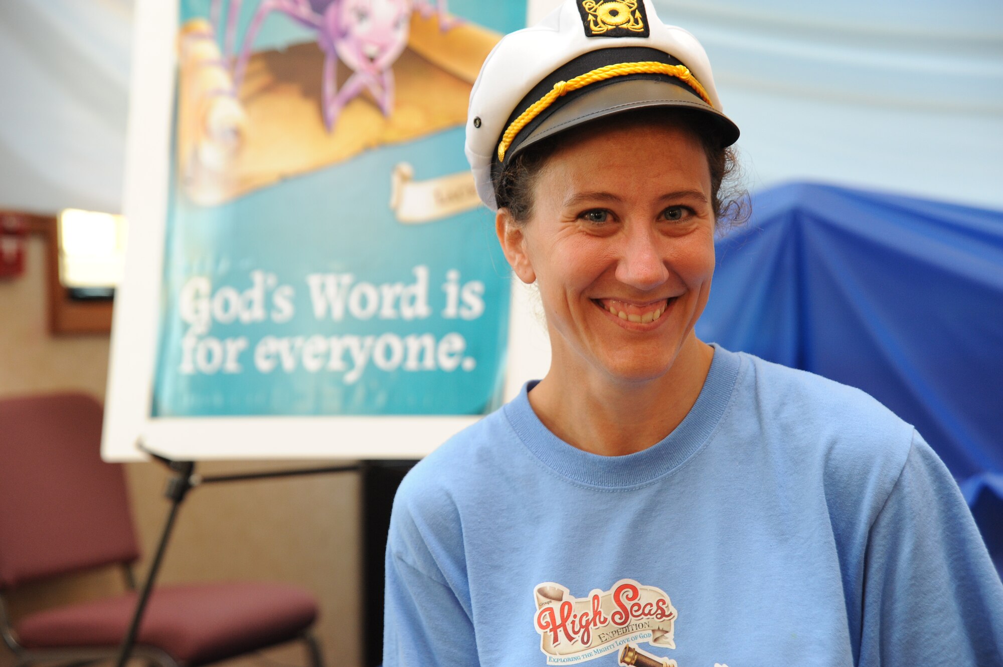 Sonja Genke, 2010 Vacation Bible School coordinator, smiles and welcomes children and volunteers to Vacation Bible School, June 18, 2010, McConnell Air Force Base, Kan.  More than 40 volunteers helped with VBS this year.  Volunteers and base chapel staff worked together to register children, order materials and build scenes since March.  The base chapel hosted VBS from June 14 to 18.  The chapel hosts VBS annually to help meet the spiritual needs of Team McConnell’s children.  (U.S. Air Force photo/Tech. Sgt. Chyrece Campbell)