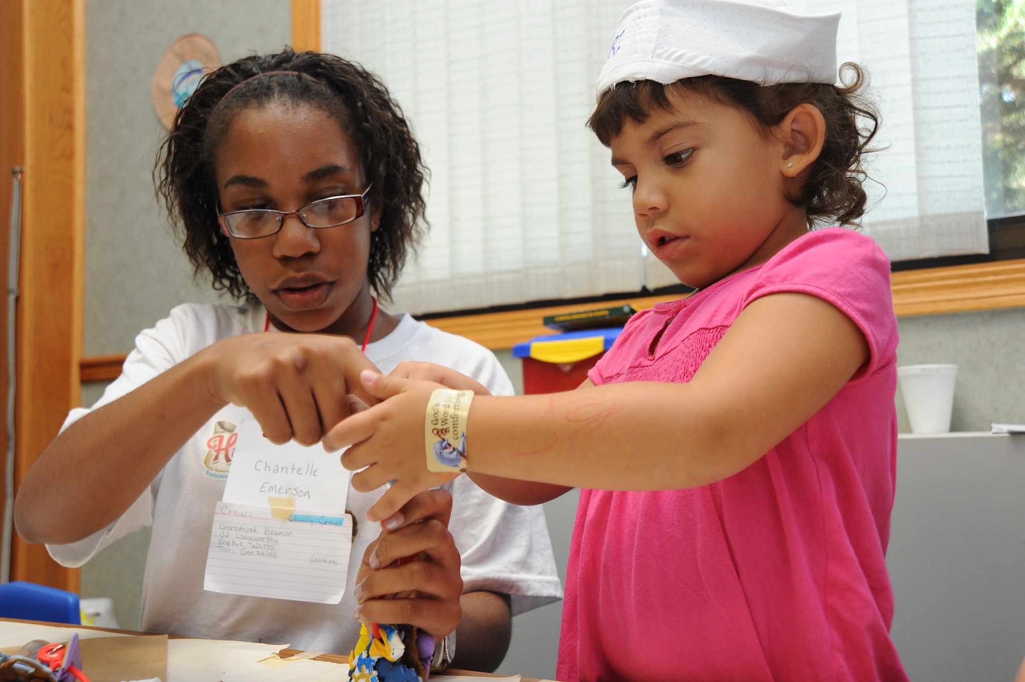 Chantelle Emerson, 13, and Tori Gonzales, 4, Team McConnell family members, assemble a sailboat keychain at Vacation Bible School, June 18, 2010, McConnell Air Force Base, Kan.  VBS crafts like this one help children understand the Bible lessons and sided in team building.  The base chapel hosted VBS from June 14 to 18.  The base chapel hosts VBS to help meet the spiritual needs of Team McConnell’s children.  (U.S. Air Force photo/Tech. Sgt. Chyrece Campbell)