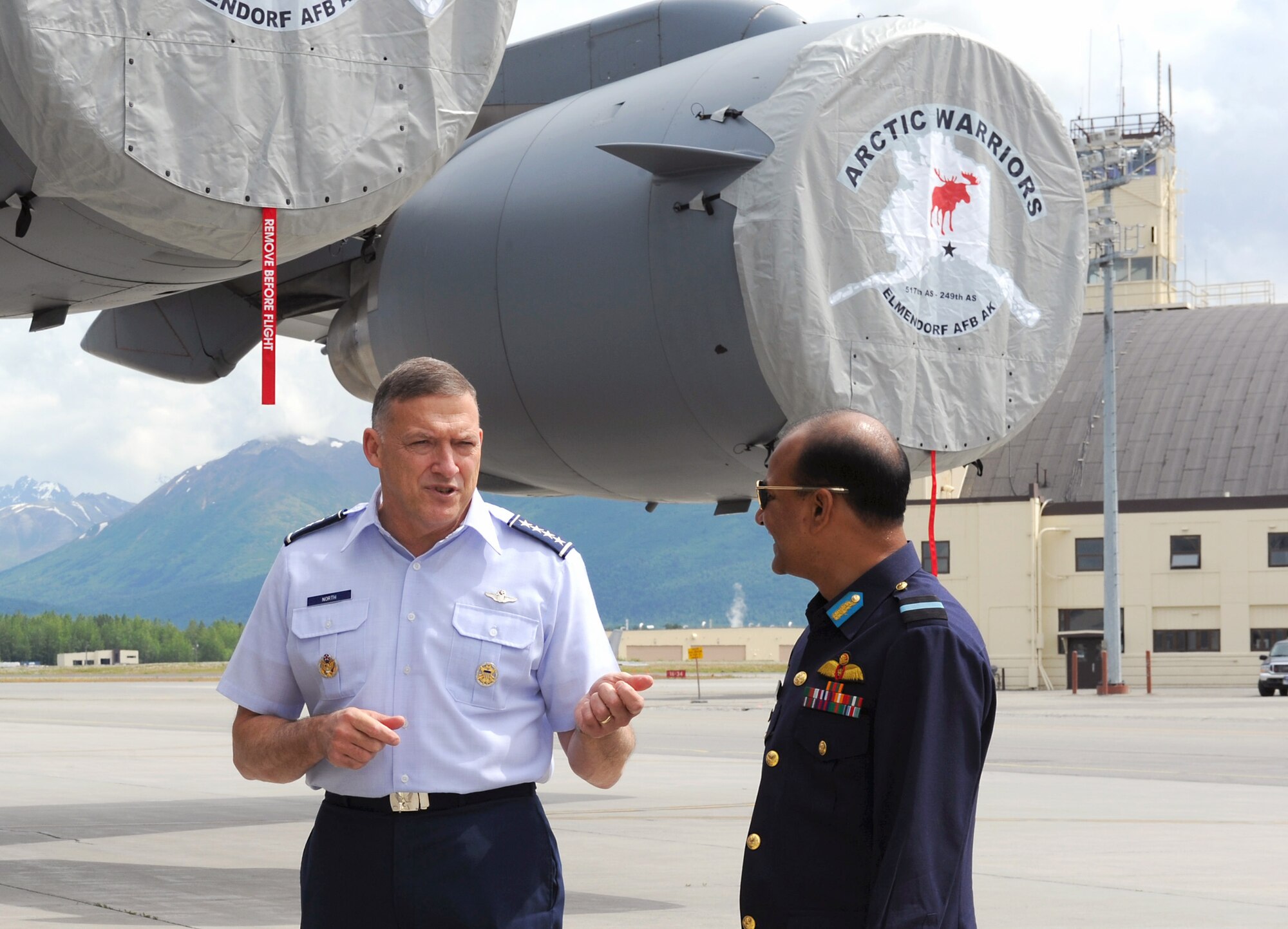 Gen. Gary L. North talks with Air Commodore M. Sanaul Huq, Air Officer Commanding, Bangladesh Air Base Zahurul Haque, on the flightline during the 2010 Executive Observer Program June 18, 2010, at Joint Base Elmendorf-Richardson, Alaska. Sixteen general officers from 16 different countries joined PACAF leaders in their premier multinational large force employment exercise while building partnerships with senior airpower leaders from the global community. General North is the Pacific Air Forces commander. (U.S. Air Force photo/Senior Airman Cynthia Spalding)