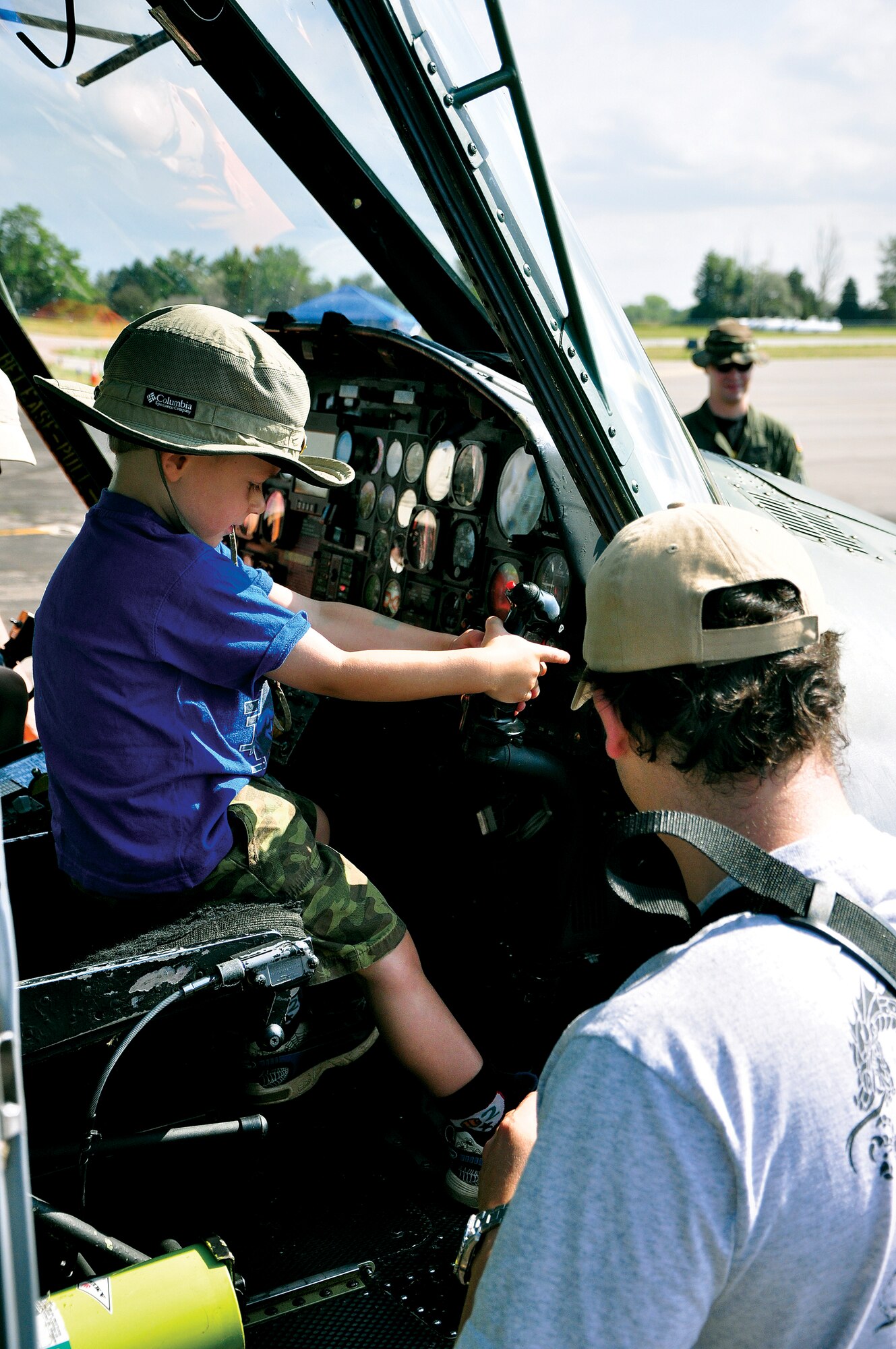 A child plays with some flight controls of a UH-1N Huey helicopter assigned to the 37th Helicopter Squadron from F.E. Warren Air Force Base on Saturday during the Boulder Airport Day at the Boulder Municipal Airport. The helicopter static display was open to the public to get a better idea of the type of missions it is used for during day-to-day operations here. (Photo by Staff Sgt. Chad Thompson)