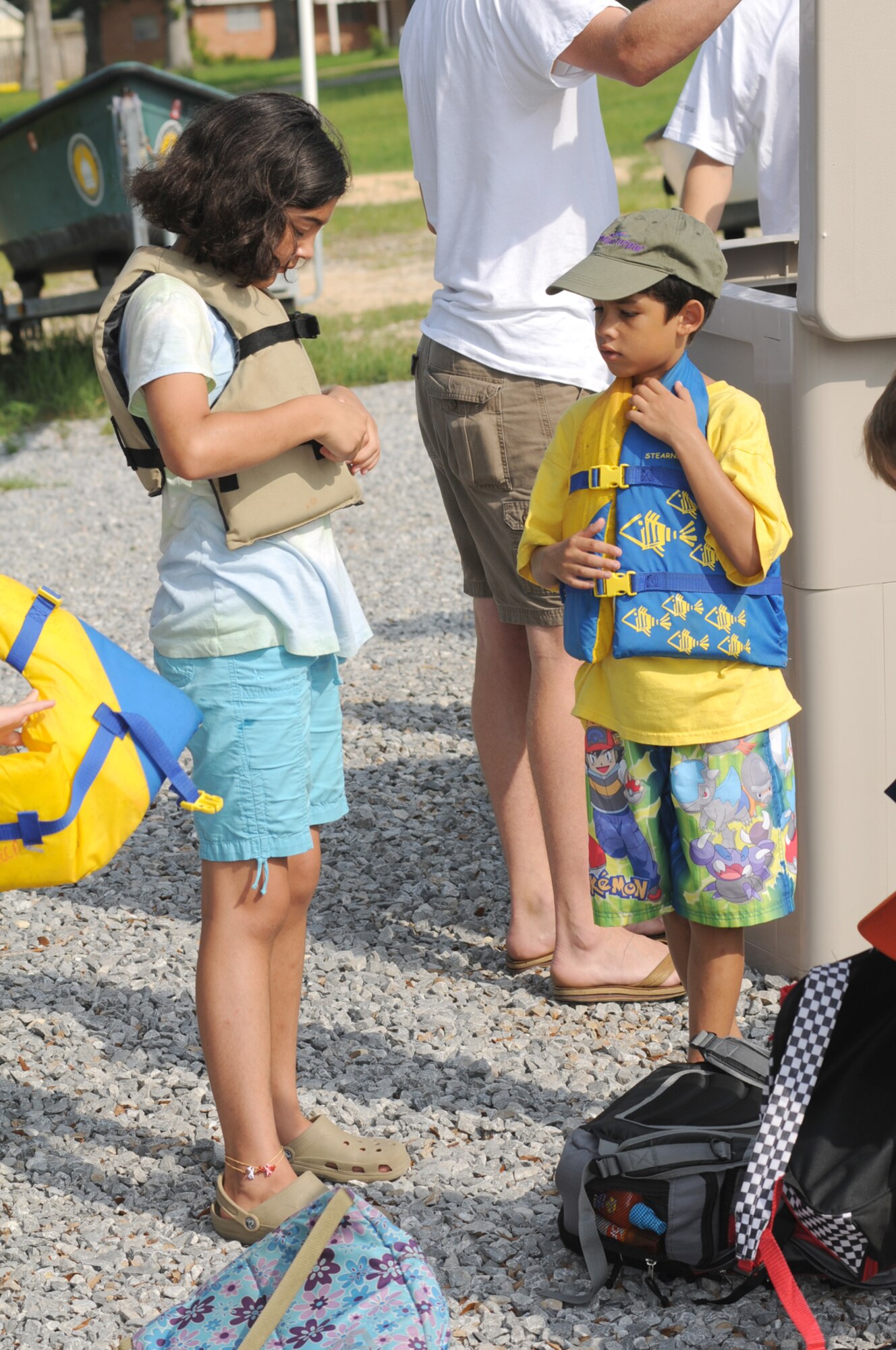 Emma and Jordan Reynolds fasten their life vests before departing for Deer Island.  Emma, 10, and Jordan, 9, are the children of Maj. Michael and Lisa Reynolds, 85th Engineering Installation Squadron.  (U.S. Air Force photo by Kemberly Groue)