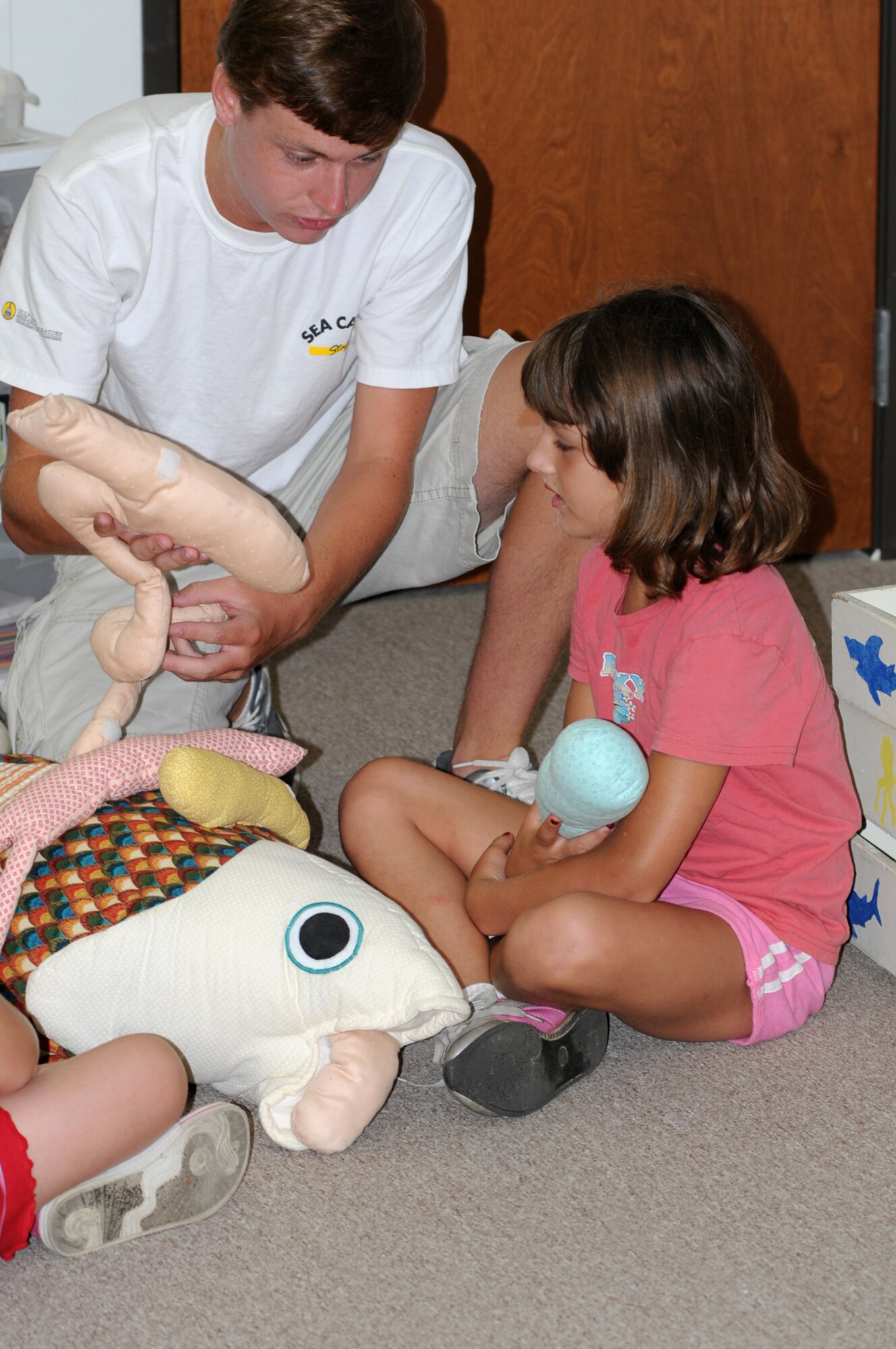 Jerrod Farrington teaches 8-year-old Rachel Hampton about fish anatomy with a stuffed model at Project Marine Discovery Sea Camp last week.  Sea Camp, now in its 23rd year, is sponsored by the University of Southern Mississippi’s Gulf Coast Research Laboratory in Ocean Springs. Rachel and her sister Sarah, who also attended the week-long camp, are the daughters of Staff Sgt. Jim and Lisa Hampton, 81st Medical Operations Squadron.  In addition to the Hampton girls and the campers pictured below, other Sea Campers who received scholarships from the Keesler Spouses Club are Dana Williams, daughter of Lt. Col. Ken and Karen Williams, 81st Surgical Operations Squadron, and Maddie Mazey, daughter of Capt. Brett and Mariah Mazey, 81st Medical Support Squadron.  The six children, who have a parent who is currently deployed or recently returned from deployment, submitted essays to the KSC to be considered for the scholarships.  (U.S. Air Force photo by Kemberly Groue)
