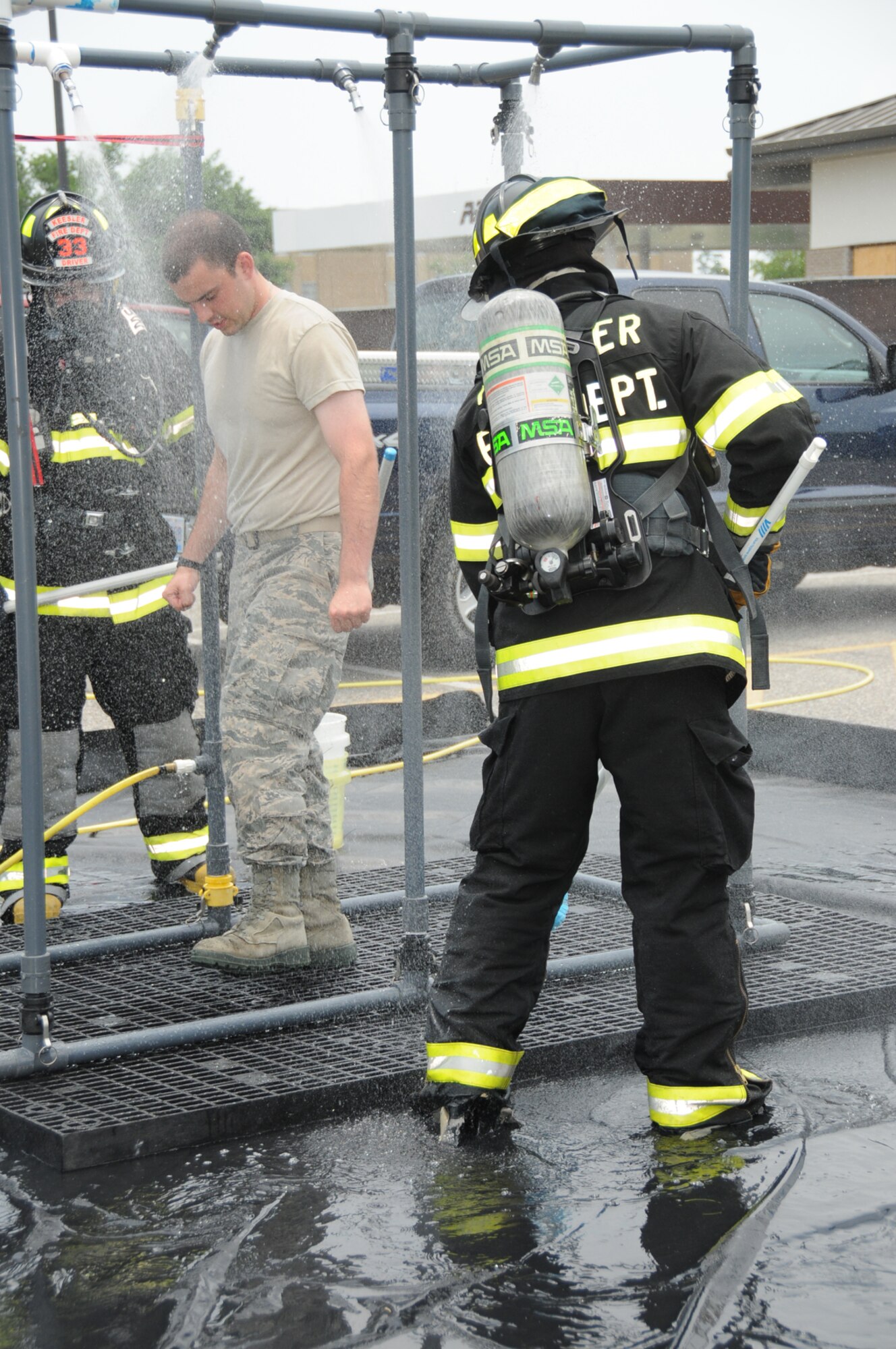 Tech. Sgt. Timothy Hogan, left, a Keesler firefighter, has his vital signs checked by Staff Sgt. Malerie Auld and Senior Airman Ryan Hartman, emergency medical technicians from the 81st Medical Operations Squadron.  During the exercise, the base was evaluated on readiness, response and recovery.  First responders were judged on their response procedures and facilities were evaluated on sheltering.  (U.S. Air Force photo by Kemberly Groue)
