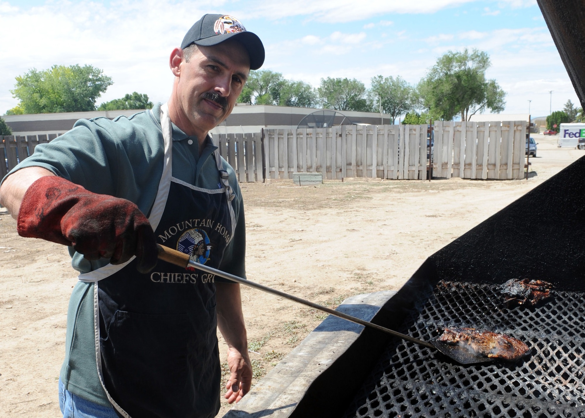 MOUNTAIN HOME AIR FORCE BASE, Idaho – Chief Master Sgt.  Thomas Parkinson, 366th Aircraft Maintenance Squadron superintendent, grills steak at the community center during a Chief’s Steak Burn June 16. Money raised from the steak burn helps offset costs of quarterly and annual awards. (U.S. Air Force photo by Airman 1st Class Debbie Lockhart)