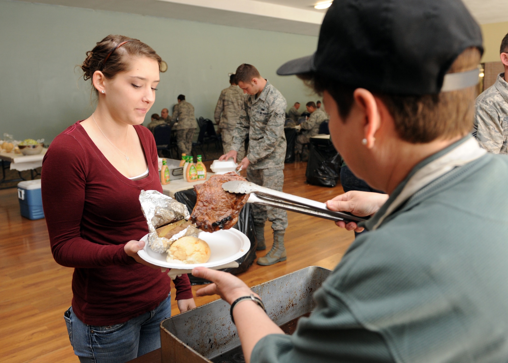 MOUNTAIN HOME AIR FORCE BASE, Idaho -- Roni Roach is served steak at the community center during a Chief’s Steak Burn June 16. Money raised from the steak burn helps offset costs of quarterly and annual awards. (U.S. Air Force photo by Airman 1st Class Debbie Lockhart)