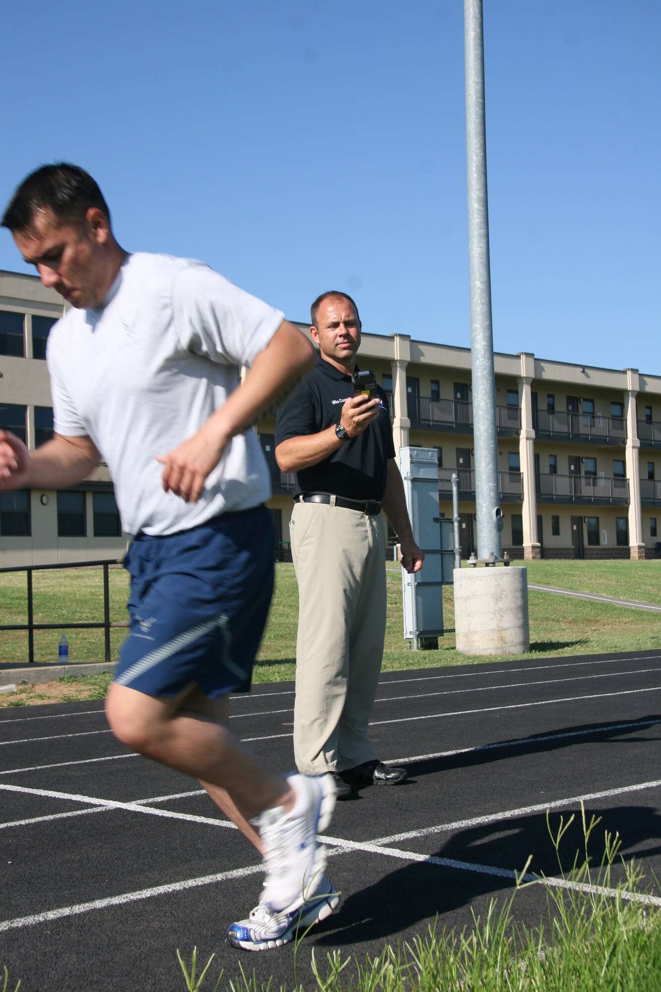 Mike Comfort, right, a fitness evaluator with the newly established Fitness Assesment Cell at Tinker, monitors a physical fitness exam recently. The Air Forces new fitness standards go into effect July 1. (Air Force photo by John Stuart)