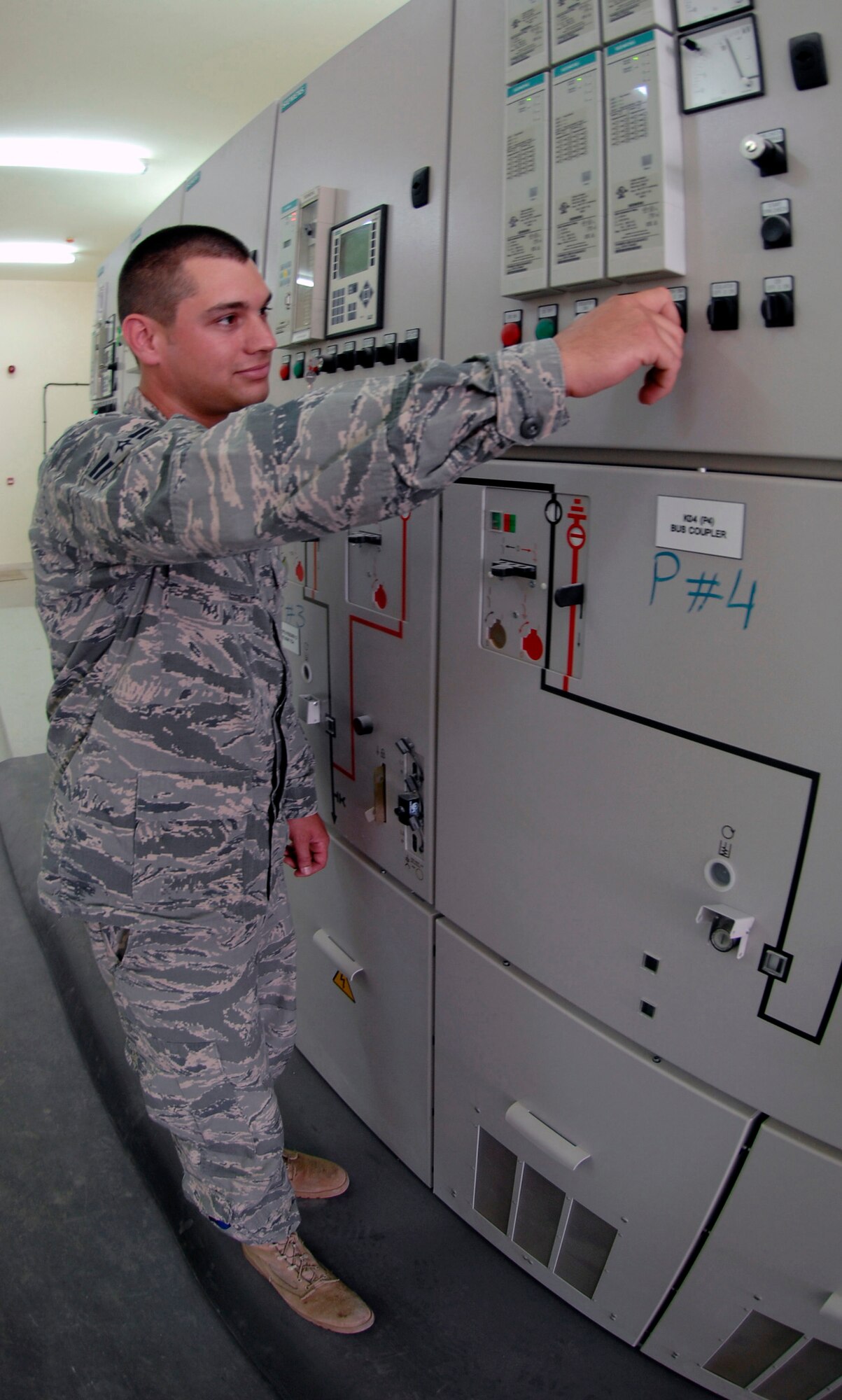 Airman 1st Class Dustin Nash,a electrical systems apprentice with the 380th Expeditionary Civil Engineer Squadron's Fire Department at a non-disclosed base in Southwest Asia, checks gauges at the high-voltage switching center. Electrical systems workers came to the forefront June 22 when the 380th AEW lost power. Their hard work after duty hours ensured power was restored as quickly as possible. Airman Nashis deployed from the 3rd Civil Engineer Squadron at Elmendorf Air Force Base, Alaska, and his hometown is Lake Odessa, Mich.(U.S. Air Force Photo/Staff Sgt. Jeremy Larlee/released)