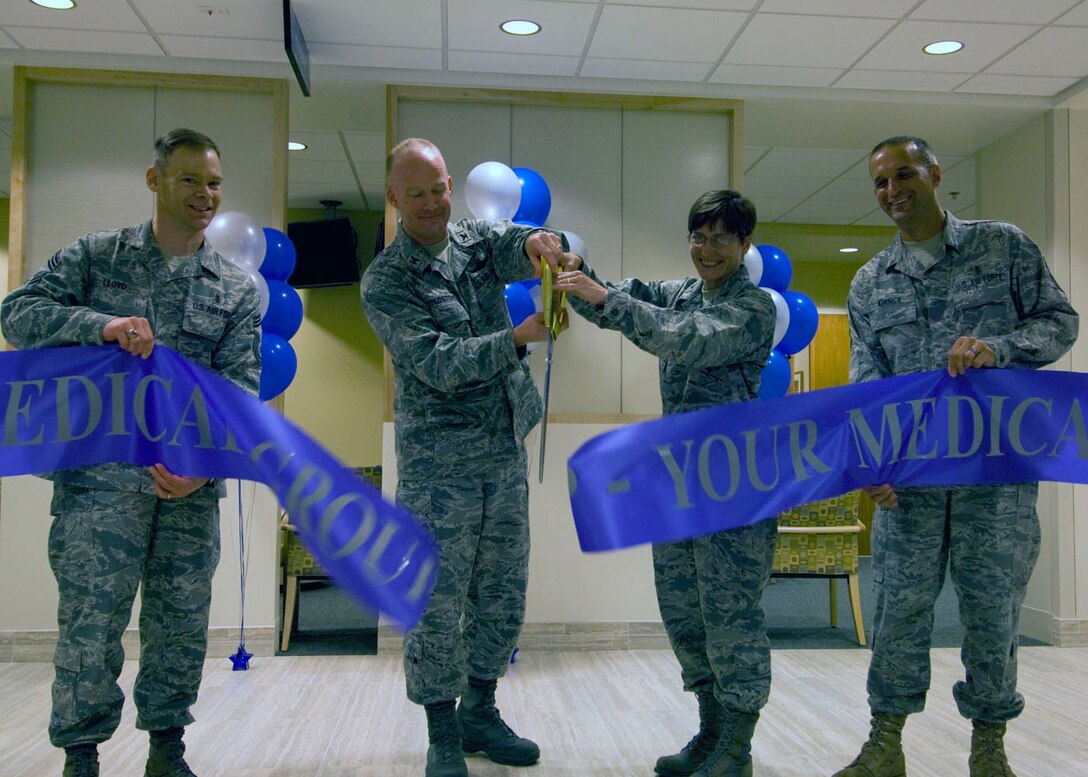 SCOTT AIR FORCE BASE, Ill. -- Col. Gary Goldstone, 375th Air Mobility Wing commander, along with Col. Jill Sterling, 375th Medical Group Commander cut the ribbon held by Chief Master Sergeants David Lloyd, 375th AMW Acting Command Chief, and Curtis Kinnick, 375th Medical Operations Squadron superintendent, announcing the official completion of the 375th MDG clinic renovation project. The $45 million project took 32 months to complete and renovated 126,000 square feet of space.(U.S. Air Force Photo by Senior Airman Andrew Davis 