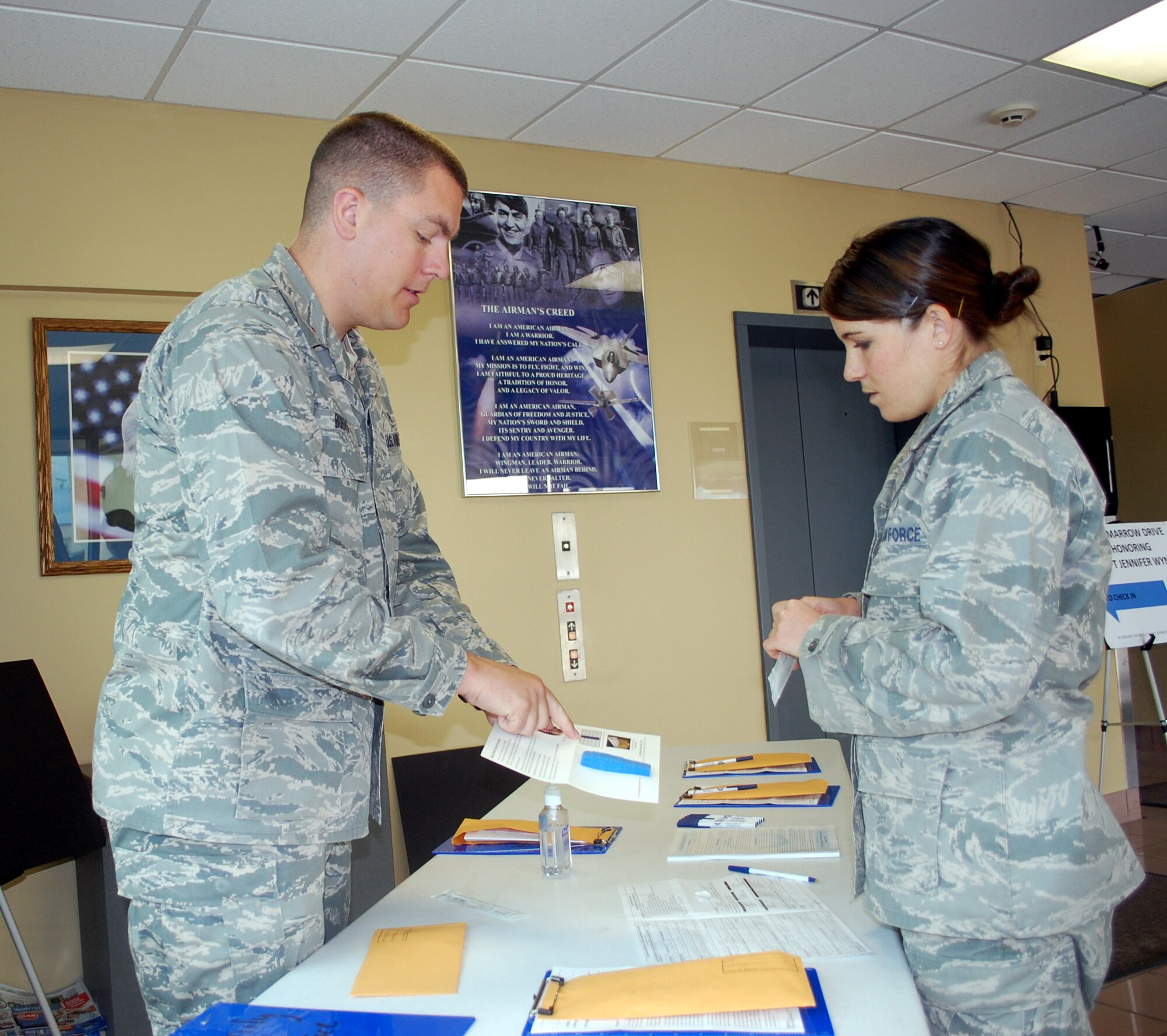 2nd Lt. Neil Boots explains the bone marrow donor testing process to 1st Lt. Marshel Slater during the final day of the 341st Medical Group's three-day donor drive at Malmstrom June 16-18. Anyone interested in being tested to become a bone marrow donor can call Lieutenant Boots at 731-3805. (U.S. Air Force photo/Valerie Mullett)