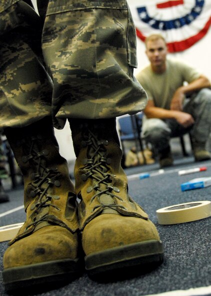 Tech. Sgt. Paul Greene, 919th Aircraft Maintenance Squadron, guides his blindfolded teammate through a field of simulated landmines during a team building exercise in week two of the NCO development course at Duke Field.  22 919th Special Operations Wing NCOs and soon to be NCOs attended the two-week course to learn about leadership, management and communication.  U.S. Air Force photo /Tech. Sgt. Samuel King Jr.