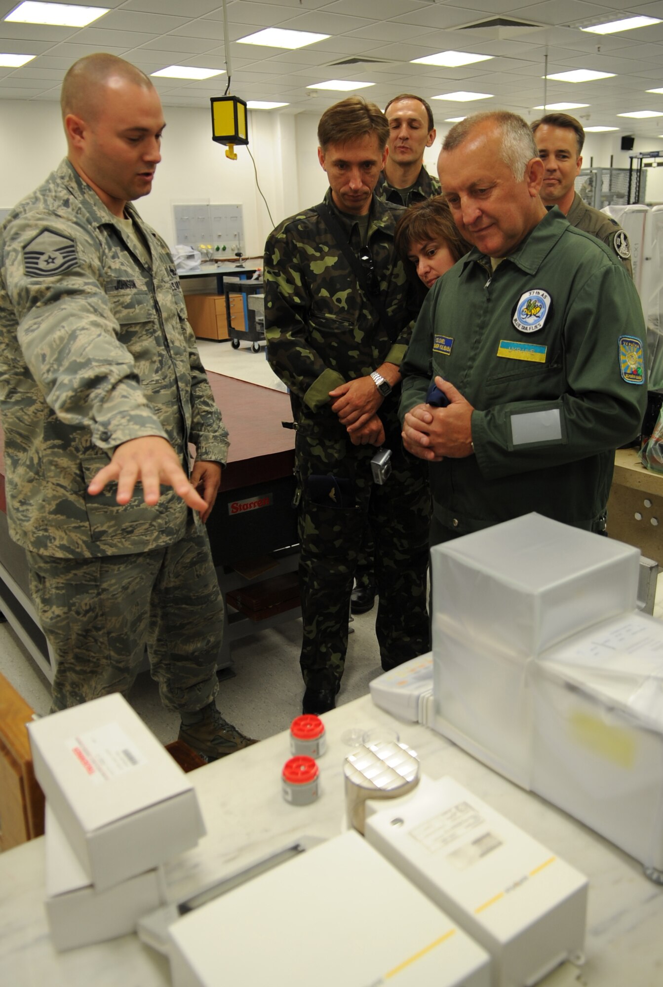 U.S. Air Force Master Sgt. Gregory Johnson, 86th Maintenance Squadron precision, measurement, equipment, laboratory (PMEL) lab chief, gives a tour of the PMEL facility during a visit to Ramstein Air Base, Germany, June 24, 2010.  The goal of the Ukrainian visit was to help advance military interoperability and build international partnerships. (U.S. Air Force photo by Senior Airman Caleb Pierce)