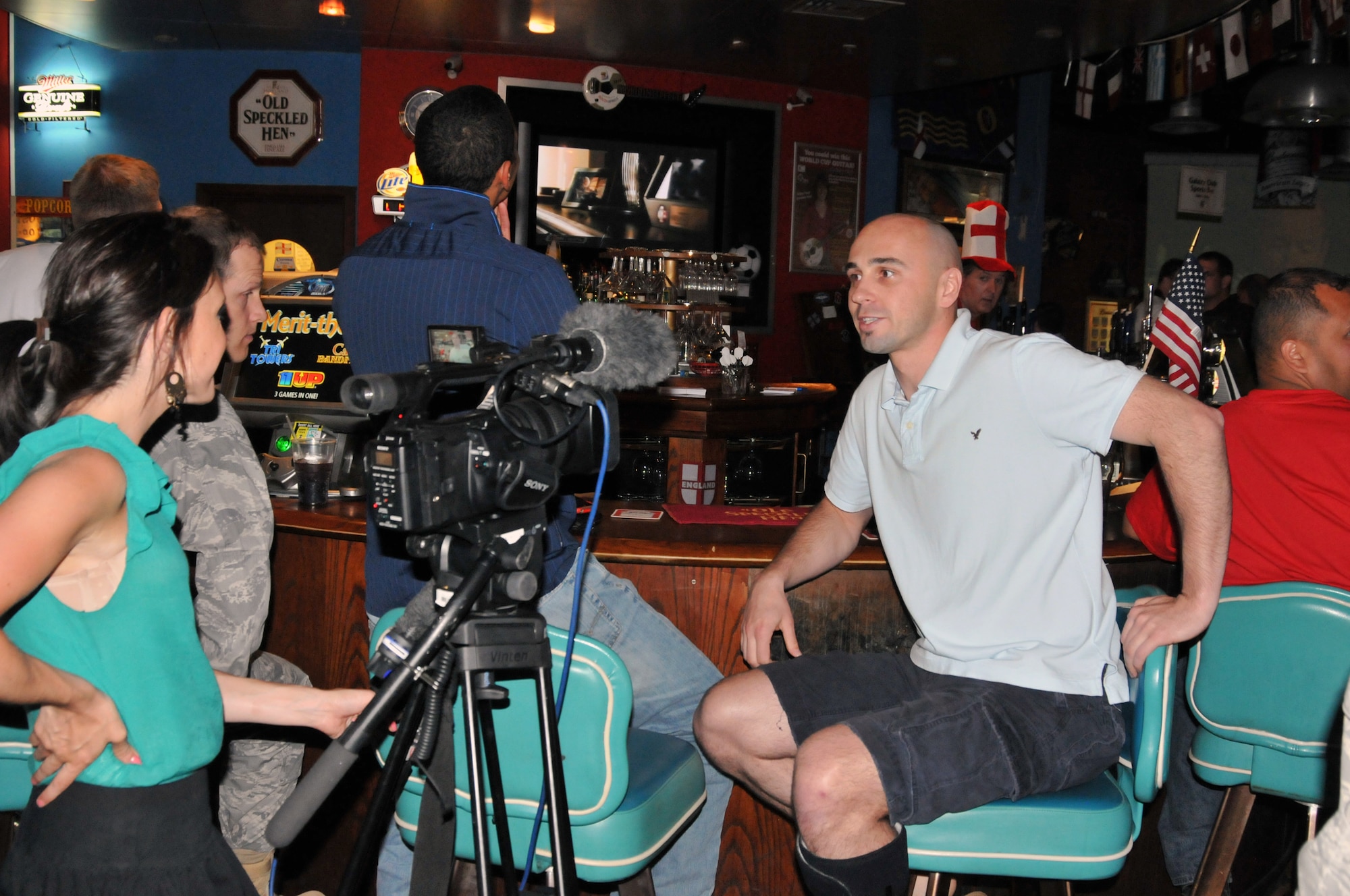 An ITV reporter interviews Staff Sgt. Janusz Jaworek, 48th Aerospace Medicine Squadron, during the USA versus Algeria 2010 FIFA World Cup South Africa soccer match aired at the Galaxy Club at RAF Mildenhall June 23. Sergeant Jaworek was one of nearly a hundred servicemembers who came out to the G-Club to show his support for Team USA, who beat Algeria 1 - 0, and put USA into the "Final16" match in pursuit of the World Cup. (US Air Force Photo/USAFA Cadet 2nd Class Lauren Delaney)
