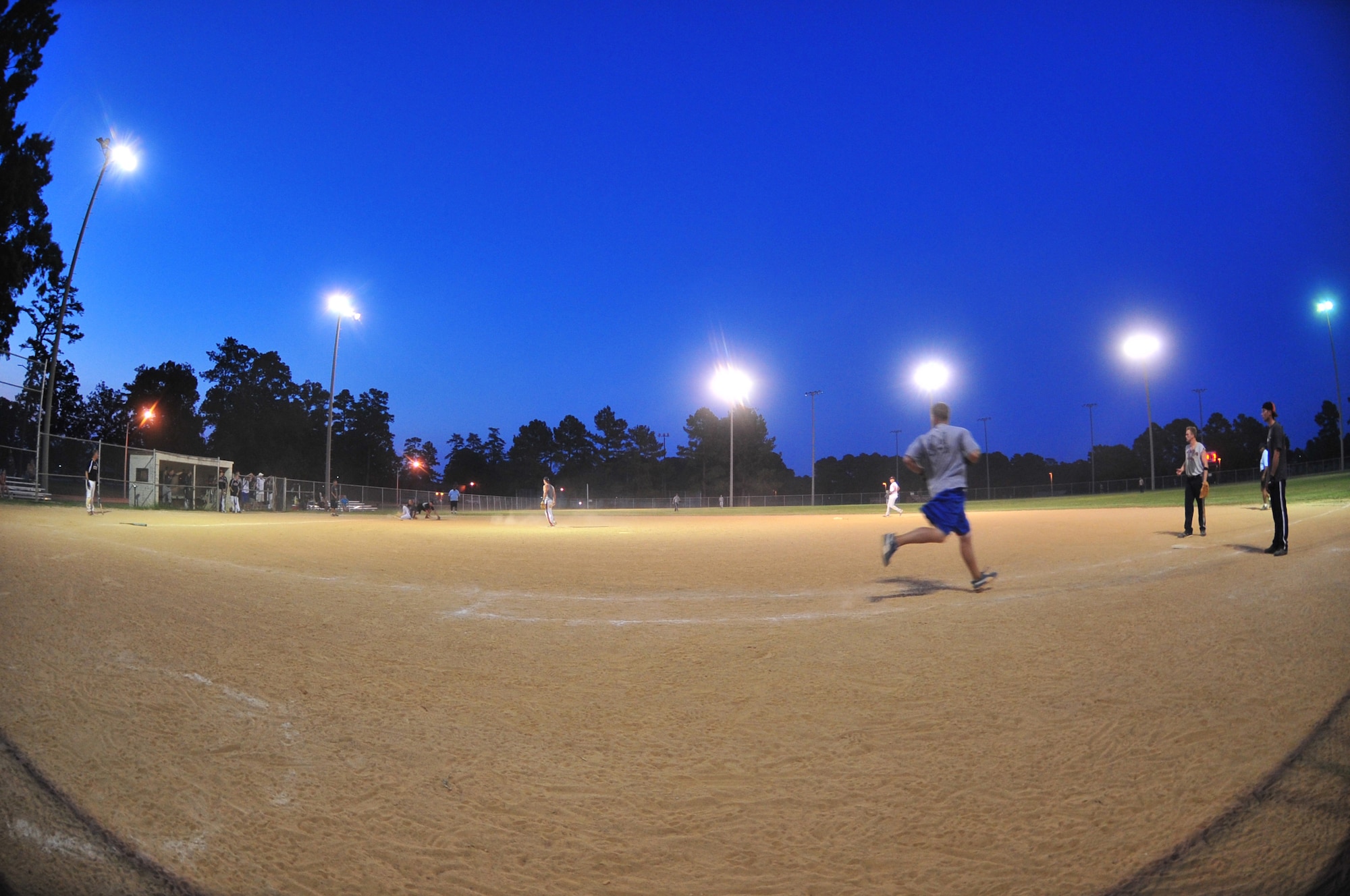 SEYMOUR JOHNSON AIR FORCE BASE, N.C. == Randy Wilhide runs to first base after hitting a line drive toward third during the Eagles Grand Slam Jamboree Softball Tournament Championship game June 21, 2010. A line drive is when the batter hits the ball low to the ground making it difficult for an outfielder to catch and make an out. Wilhide is a member of the 4th EMS Ammunition Flight team and hails from York, Pa. (U.S. Air Force photo/Senior Airman Rae Perry)