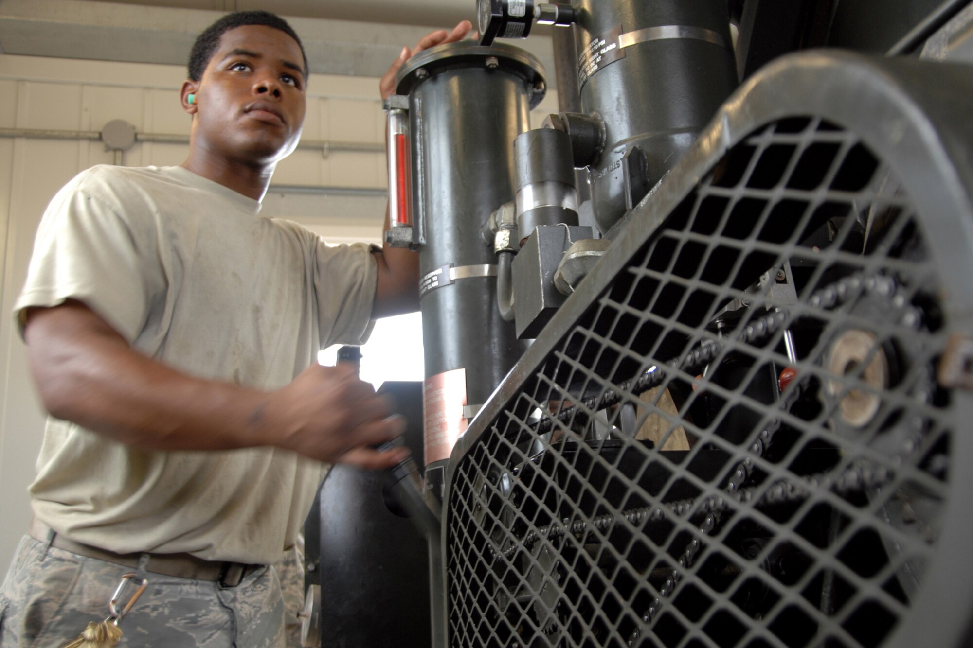 ANDERSEN AIR FORCE BASE, Guam -- Senior Airman Bryon Wilant, 36th Civil Engineer Squadron power production journeyman, operates an Aircraft Arresting System. Power production successfully completed the certification of two barrier arresting kits on the flightline, June 19. (U.S. Air Force photo by Airman 1st Class Anthony Jennings)