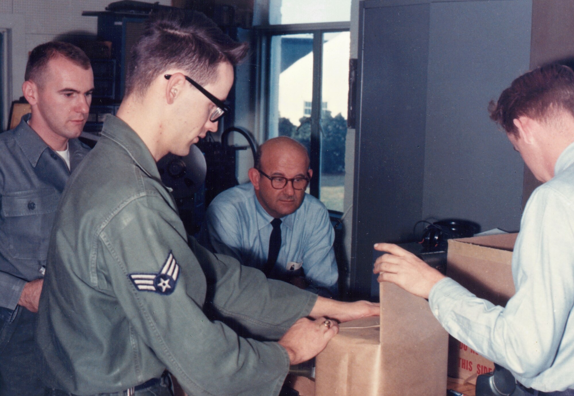 From November, 1964: This photograph is of John Bailey, Gerry Schwinger, Al Derecki and John Long who worked in the Audio Section of The United States Air Force Band.  Please take a moment to reflect on the photograph shown here. If you have any insight regarding who is in it, when or where it was taken, or any stories you can share about the event, please email our Band Historian <a href="mailto:usafbandhistorian@afncr.af.mil">Technical Sgt. Tracey MacDonald</a>. Thank you and we look forward to hearing from you!  This is Photo 33. (Unknown Photographer)