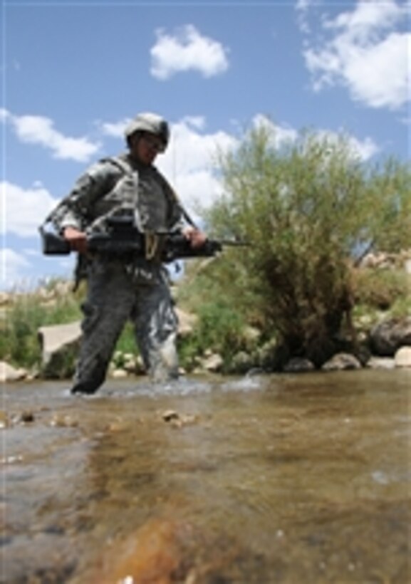 U.S. Army Spc. Brandon Rodriguez crosses a stream while patrolling the area surrounding Forward Operating Base Baylough in Zabul province, Afghanistan, on June 21, 2010.  Rodriguez is from 1st Platoon, Delta Company, 1st Battalion, 4th Infantry Regiment, U.S. Army Europe.  